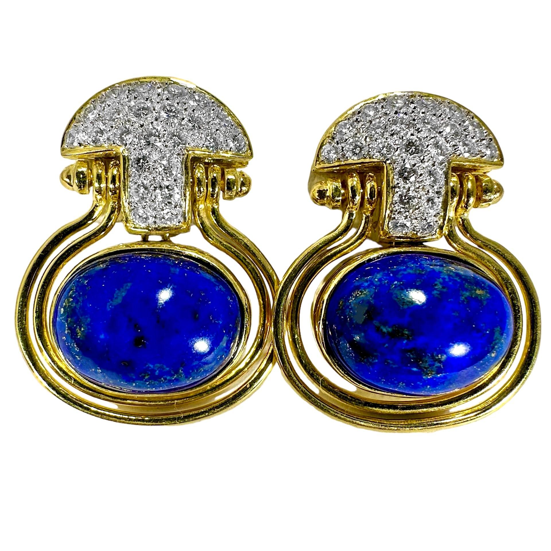 This very well crafted pair of 18k yellow gold late-20th Century earrings are bezel set with two beautifully variegated  Lapis Lazuli cabochons. This bezel set component is suspended from a bombe dome which is heavily encrusted with fine quality
