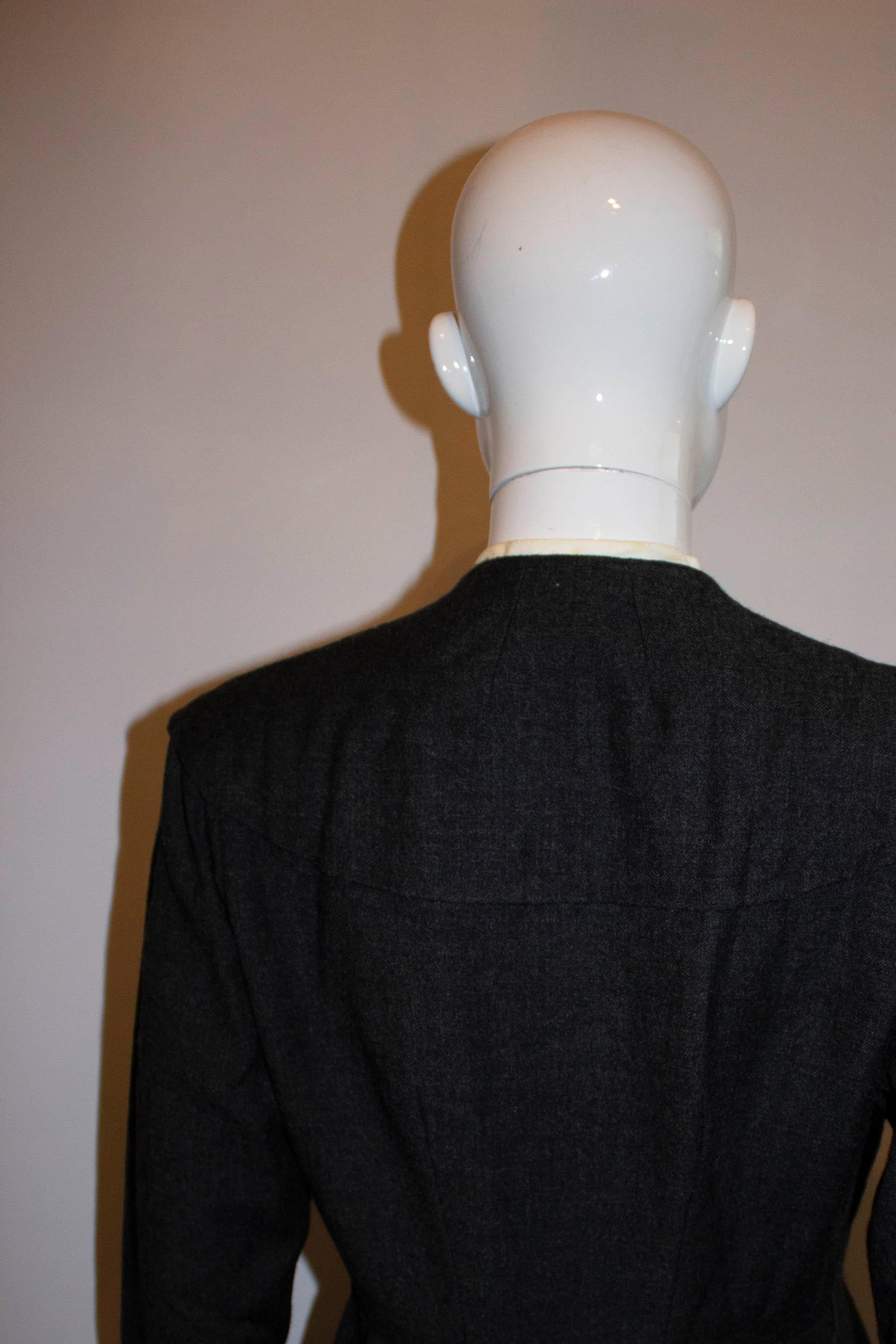 A super chic vintage tailored coatdress. The dress has a white lining at the collar, elbow length sleaves and a double row of buttons. It is  unlined.

Mesurements: Bust 37'' , waist 27'', length 47''