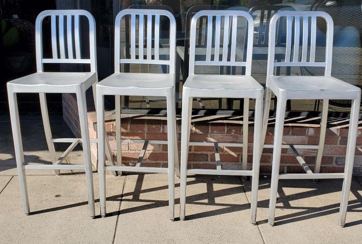 4 vintage Tall Brushed Aluminum Indoor Outdoor Bar Stools.

These Sturdy Brushed Aluminum Indoor Outdoor Bar Stools Are Very Comfortable With A Vertical Slat Back.

Each Stool Has Some Imperfections Of Use With Scuffing At The Base Of The Legs And