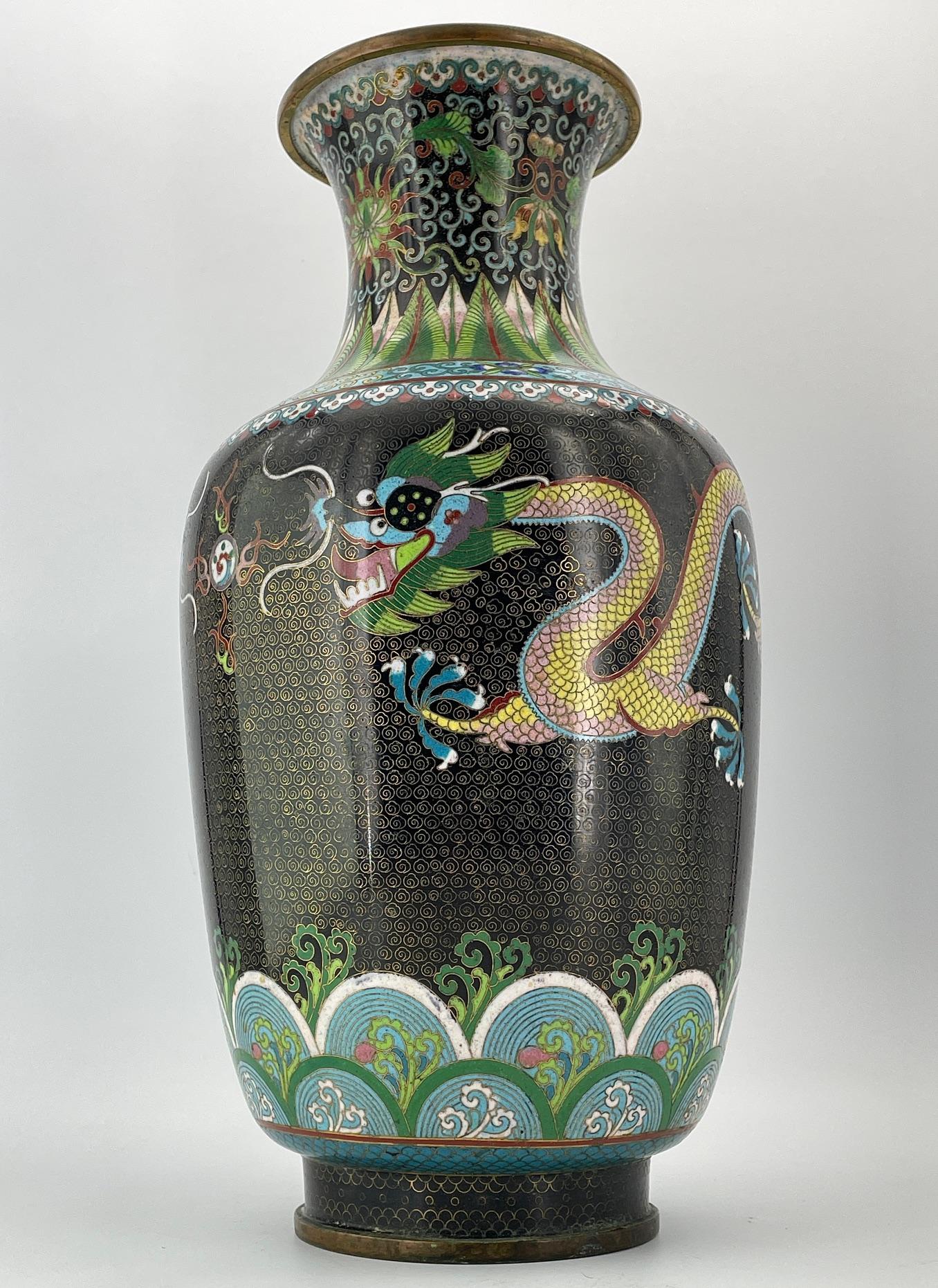 Magnificent hand-crafted Chinese Cloisonné vase, very tall with facing Dragons, from a time capsule estate in Washington D.C.  14 1/2 Inches tall and so highly detailed it is sure to capture everyone’s attention.

However, this piece is in