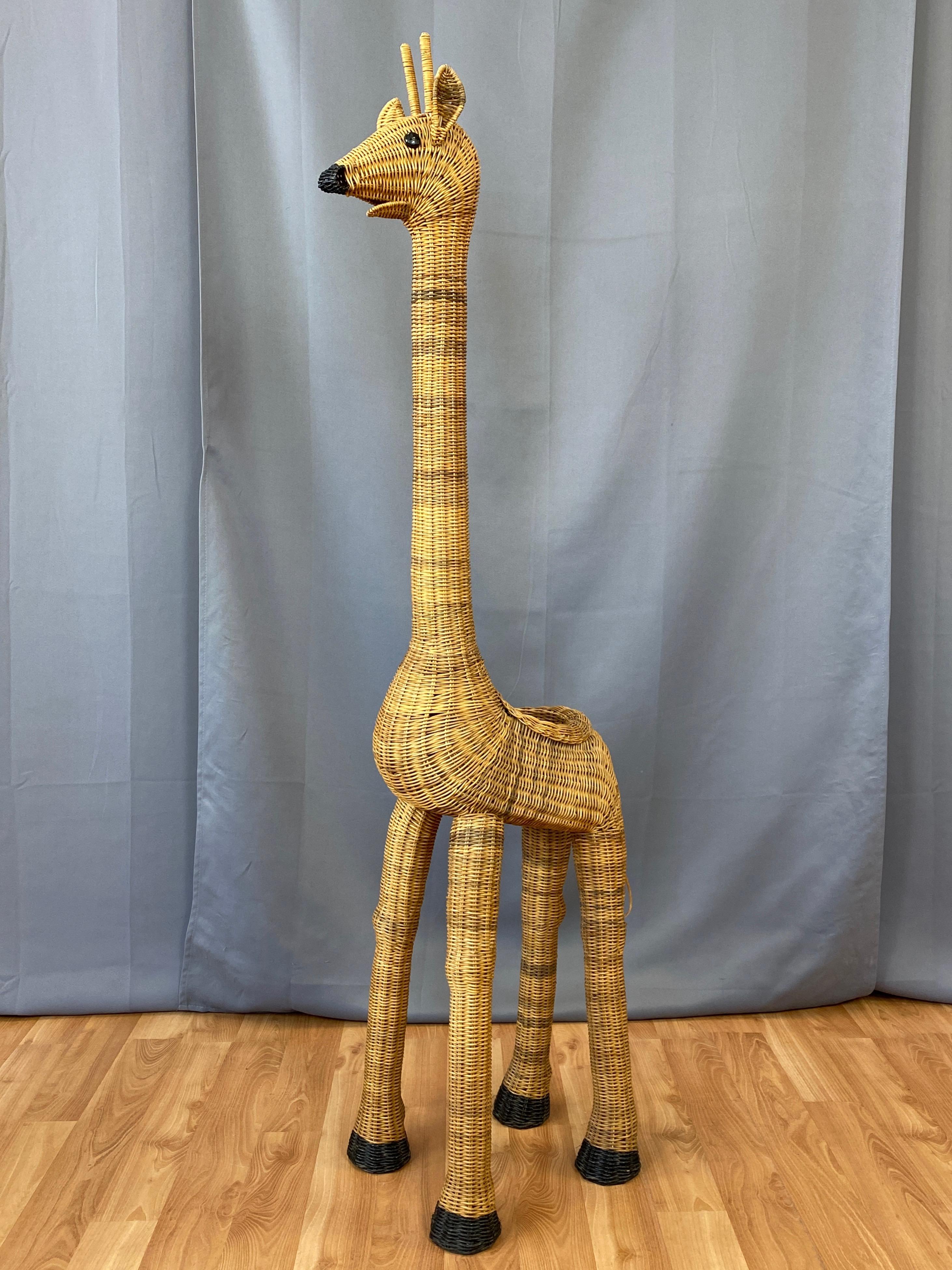 An utterly charming vintage five-foot-tall wicker giraffe plant stand, originally produced in the 1960s and into the 1970s.

Exceptionally well-crafted of handwoven and shaped natural wicker that displays attractive subtle tonal variations