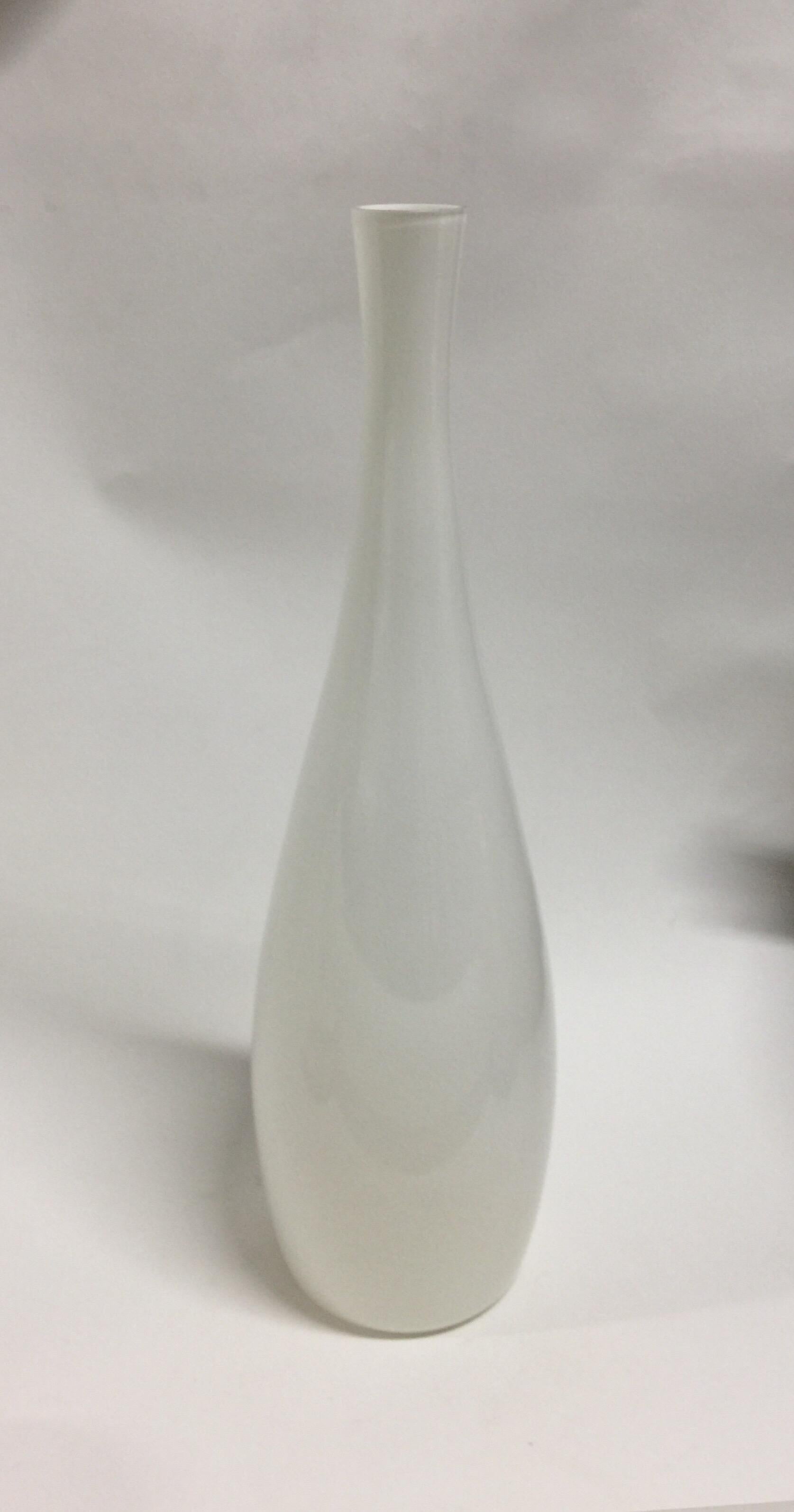 A vintage and tall art glass vase made by Jacob Bang for Kastrup. Denmark, circa 1950.

White. Made of cased glass with a beautiful iridescent quality. Retains partial original label on base. Overall in good condition; please note that top of vase