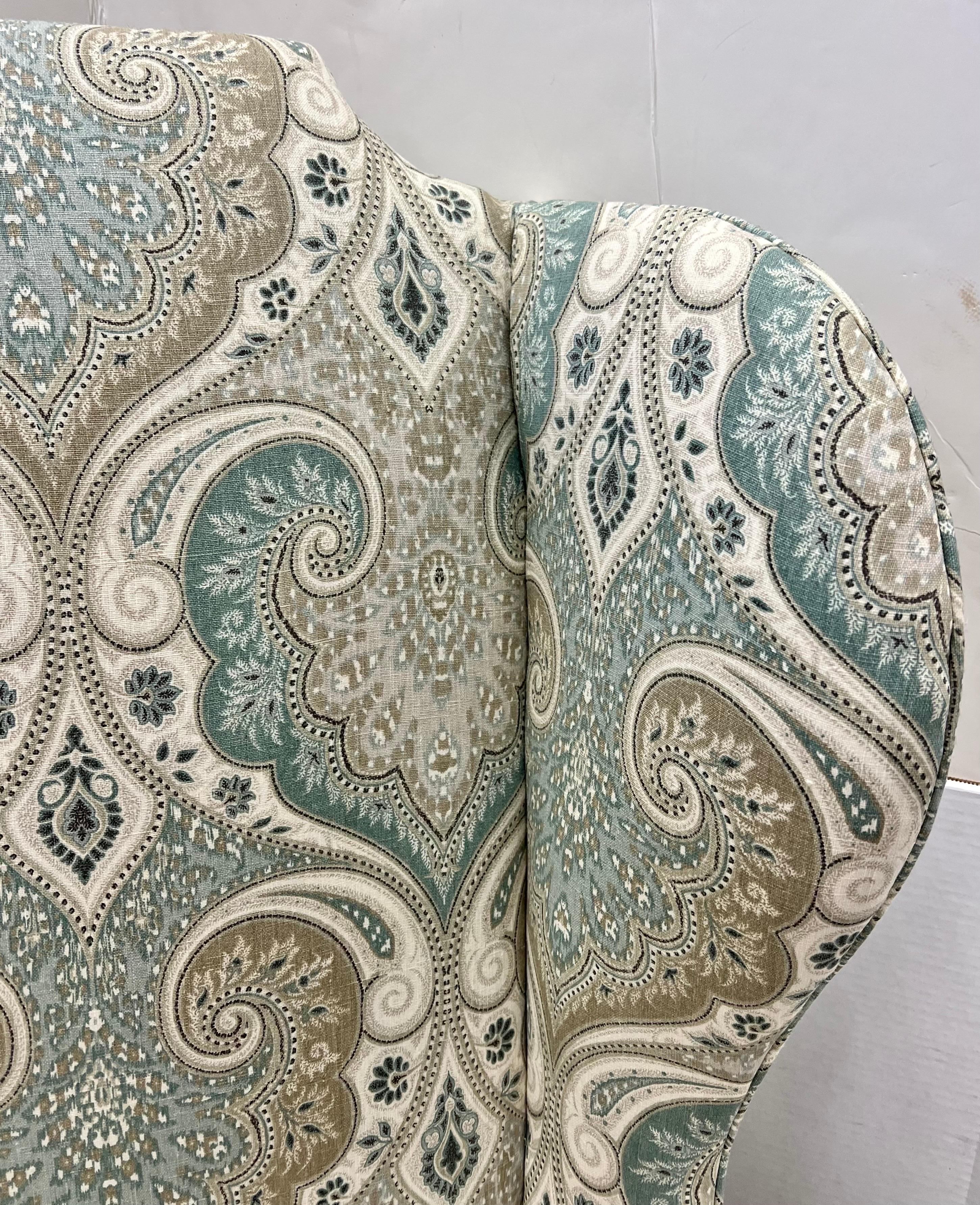 Stunning vintage tall wingback chair as it stands taller than most. Recently upholstered in a luxurious Scalamandre paisley fabric which is a showstopper. A great chair to read in or entertain guests. Fabric colors are blue, green and