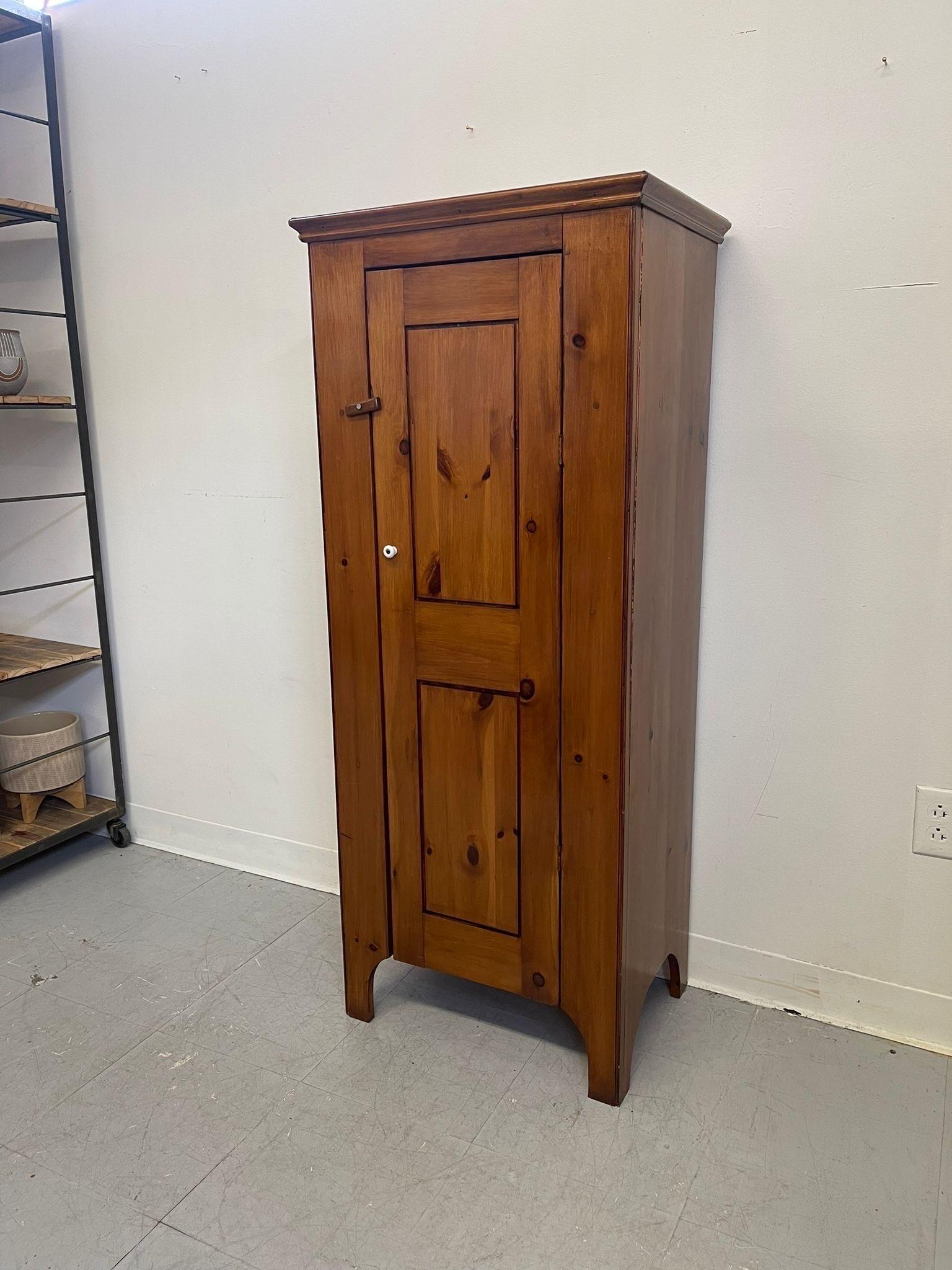 The interior of this cabinet has 4 stationary wooden shelves. White colored Hardware. Small latch on the front prevents the door from sliding open. Vintage Condition Consistent with Age as Pictured.

Dimensions. 21 W ; 15 D ; 52 H
