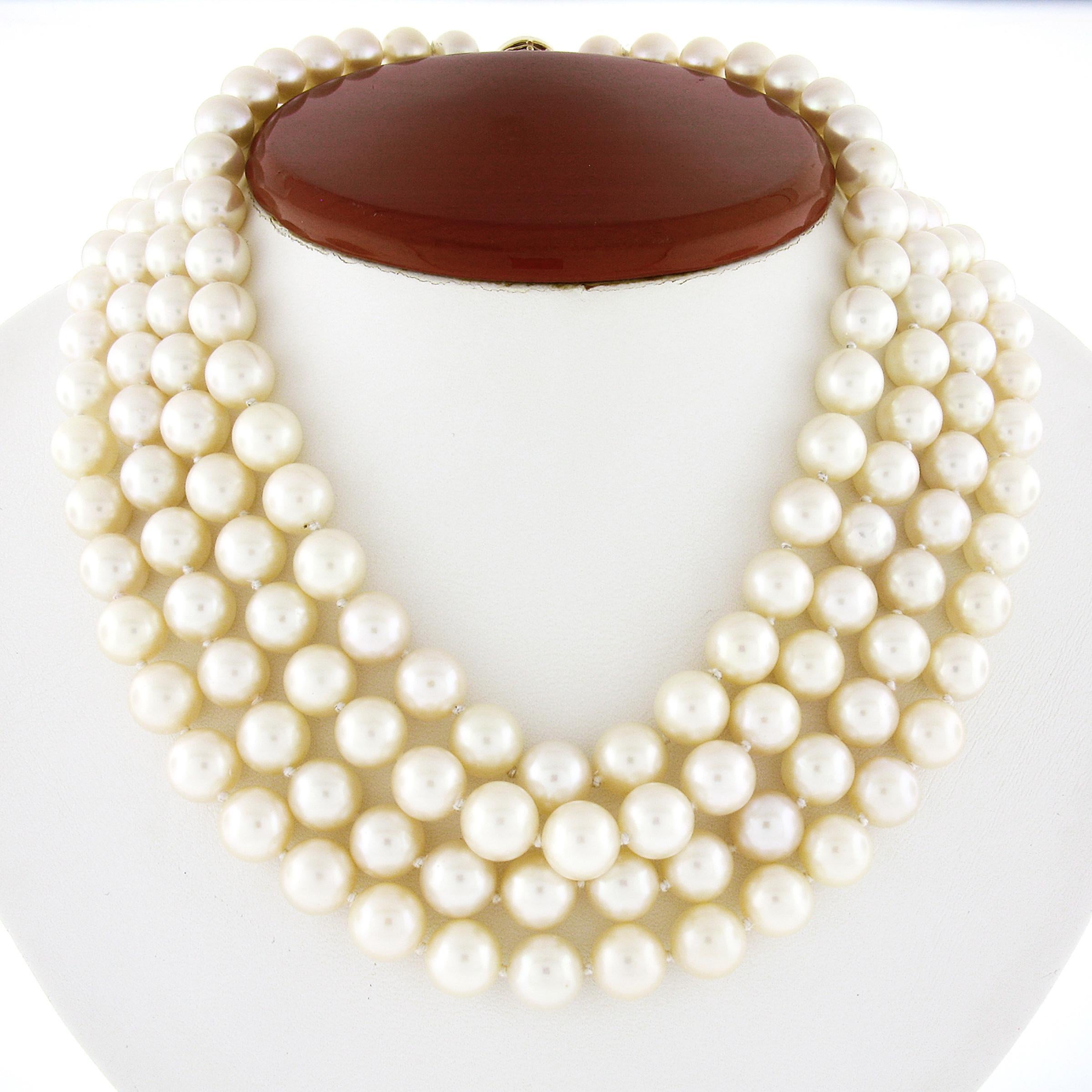 This magnificent vintage statement necklace was designed by Tambetti and features 4 strands of cultured pearls that are elegantly strung throughout. These beautiful pearls slightly graduate in size from 8.5-9.5mm with the largest at the center of