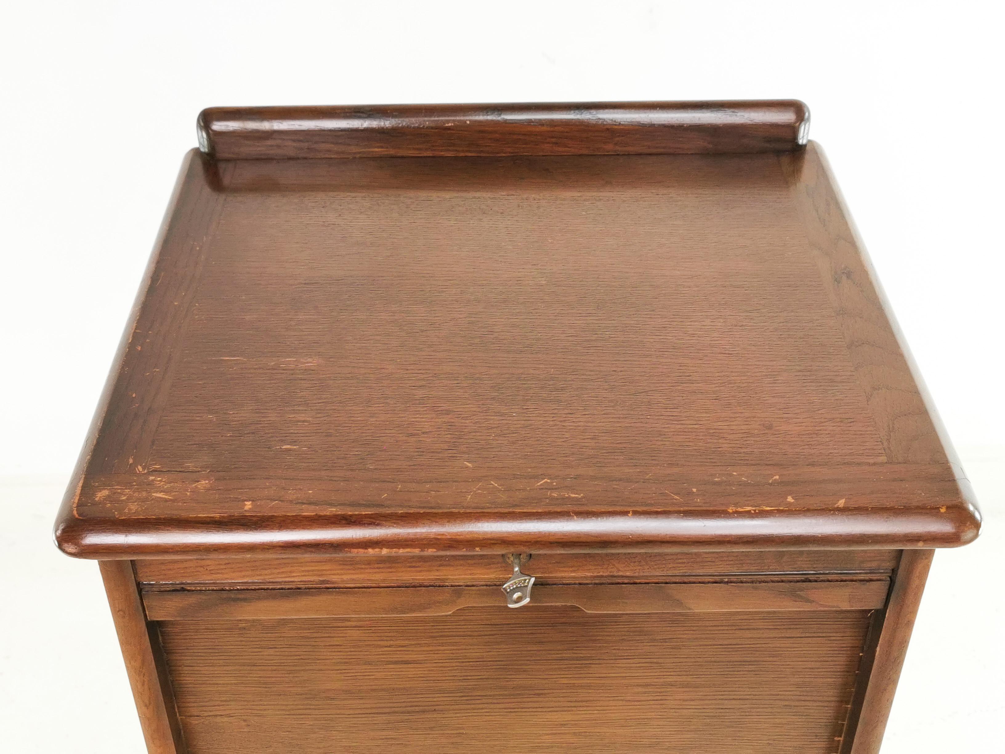 Tambour cabinet 

An excellent example of a lockable (key included) Oak tambour office haberdashery cabinet by Abbess,

Circa 1940. The unit features drawers with original nameplates.

Traditionally offices opted for tambour doors because they