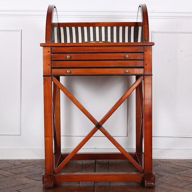 A very unusual vintage bar, the domed tambour top opening to reveal a fitted interior with various compartments above a useful pull-out surface for mixing drinks, the whole raised on simple square legs with ‘X’ stretchers.

 