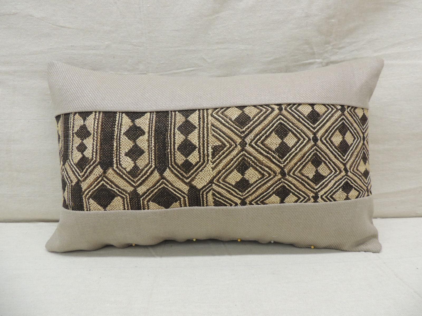 Vintage tan and black African Kuba lumbar decorative pillow
with weave woven grey linen frame and backing.
Decorative pillow handcrafted and designed in the USA. 
Closure by stitch (no zipper closure) with custom made pillow insert.
Size: 12
