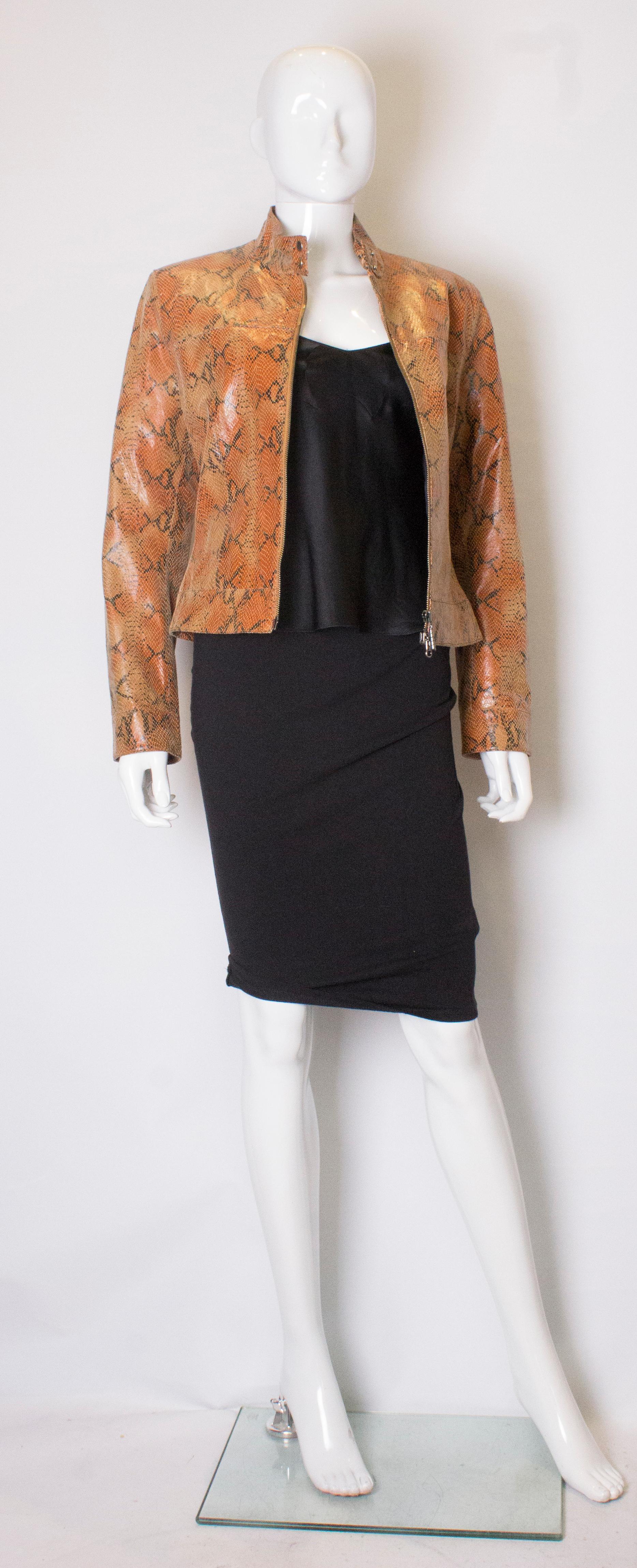 A great vintage snakeskin jacket , ideal for Spring. The jacket has 2 popper cuffs, and a 2 popper collar, with  a zip up front. It is fully lined.