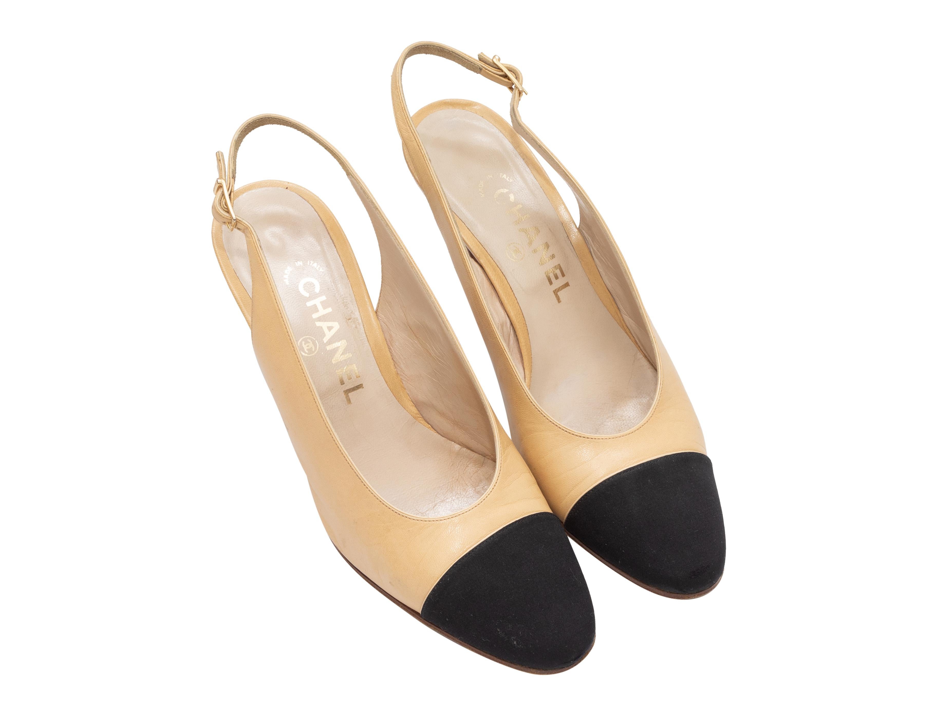 Vintage tan and black leather cap-toe slingback heels by Chanel. Gold-tone buckle closures at slingback straps. 3