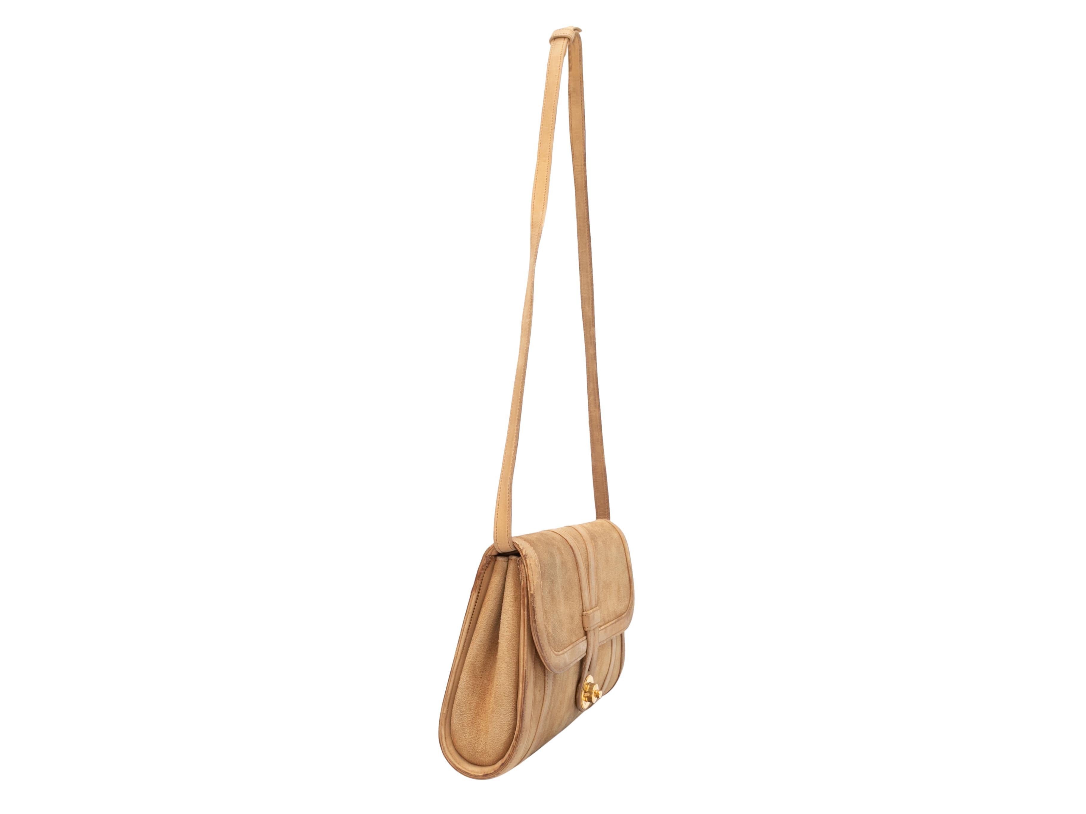 Vintage Tan Hermes 1970s Suede Shoulder Bag. This shoulder bag features a suede body, gold-tone hardware, a single flat shoulder strap, and a front clasp closure. 10.5