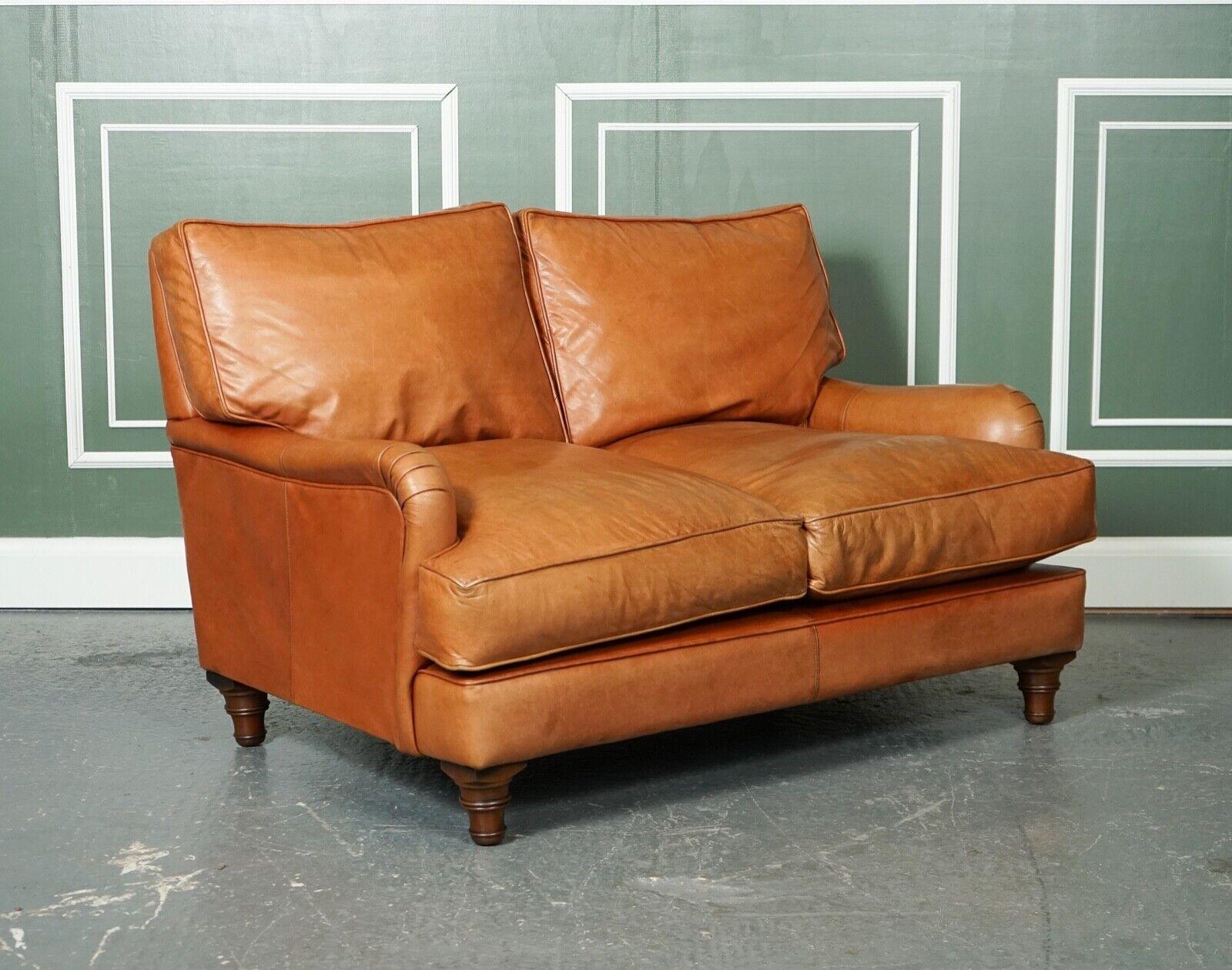 We are so excited to present to you this lovely vintage tan leather Howard-style sofa.

Lovely Howard style sofa with duck feather-filled cushions, seat and back cushions.

The leather after being waxed feels very soft and has much life left,
