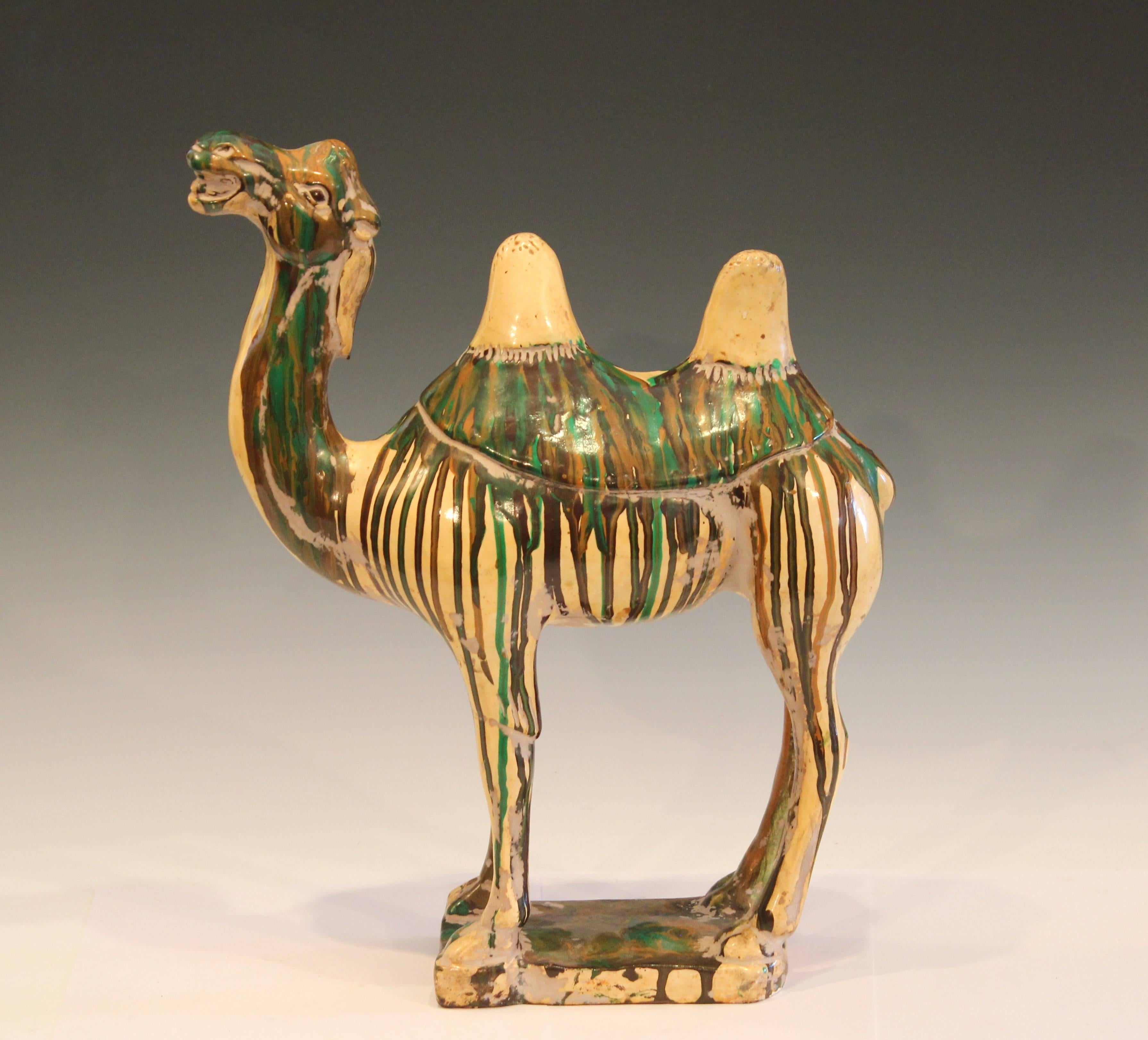 Vintage Chinese Tang style double hump camel figure, circa mid-20th century. Chinese? Italian? Has a lively presence with smirking grin, humps and tail askew, and strong contrasting drip glaze with passages of marbleization. Measure: 15 1/2