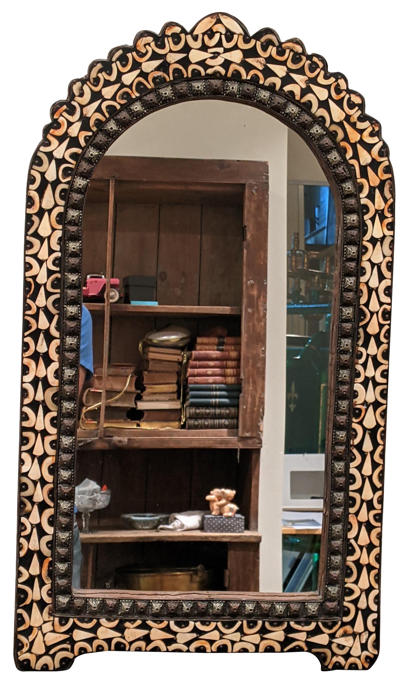 Metal and bone inlay Moroccan wall mirror, shaped like an arched window with a scalloped top edge and a stamped metal border. Marked Tangier 2014 on backside. Measure: 30