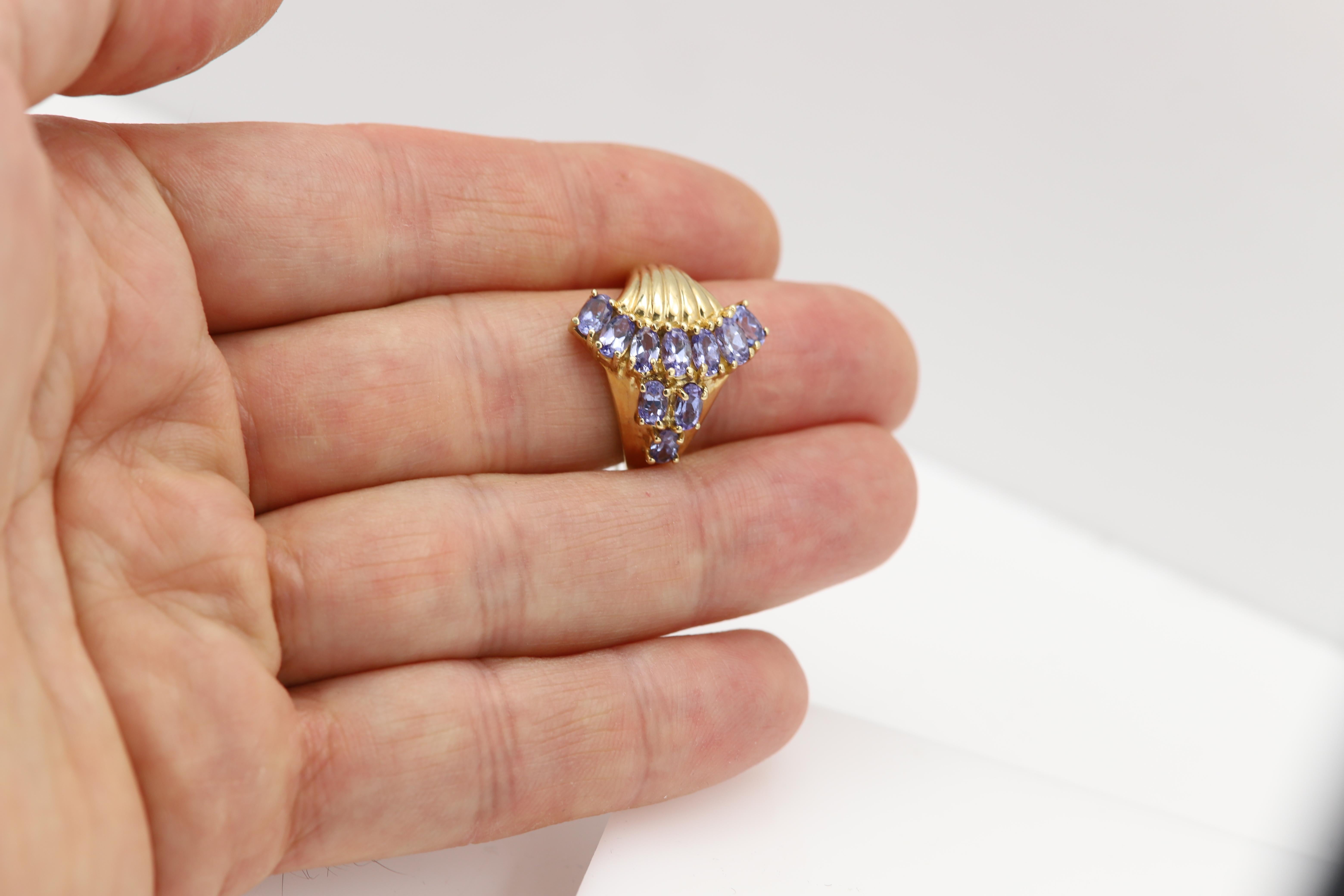 Vintage - as new 
Cluster Purple Oval Tanzanite Natural Gemstone
10k Yellow Gold 6.20 grams
Finger size 8 (can be re-sized)
Condition: Vintage- old Jewelers inventory- Pre owned- as new.
Approx width 20mm
Each stone approx 5x3mm
Gift box and