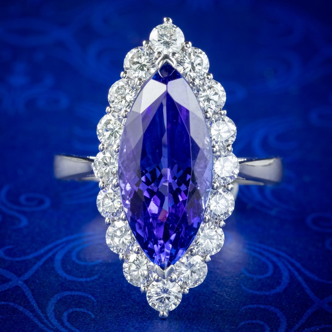 A stunning navette cluster ring built around a magnificent marquise cut tanzanite with an intense, deep blue hue with flashes of violet. It’s complete with a valuation which states the stone is an estimated AAA grade with eye-clean clarity and