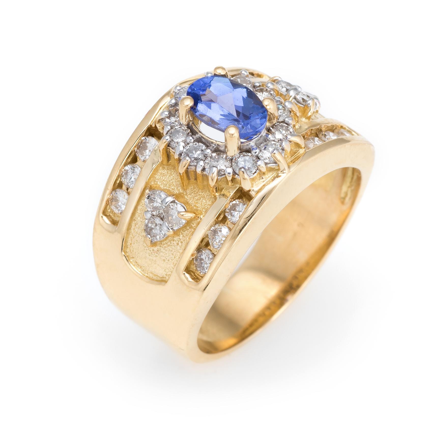 Finely detailed vintage diamond & tanzanite cigar band, crafted in 18 karat yellow gold. 

Centrally mounted tanzanite measures 6mm x 4mm (estimated at 0.75 carats), accented with 30 estimated 0.01 carat round brilliant cut diamonds. The total