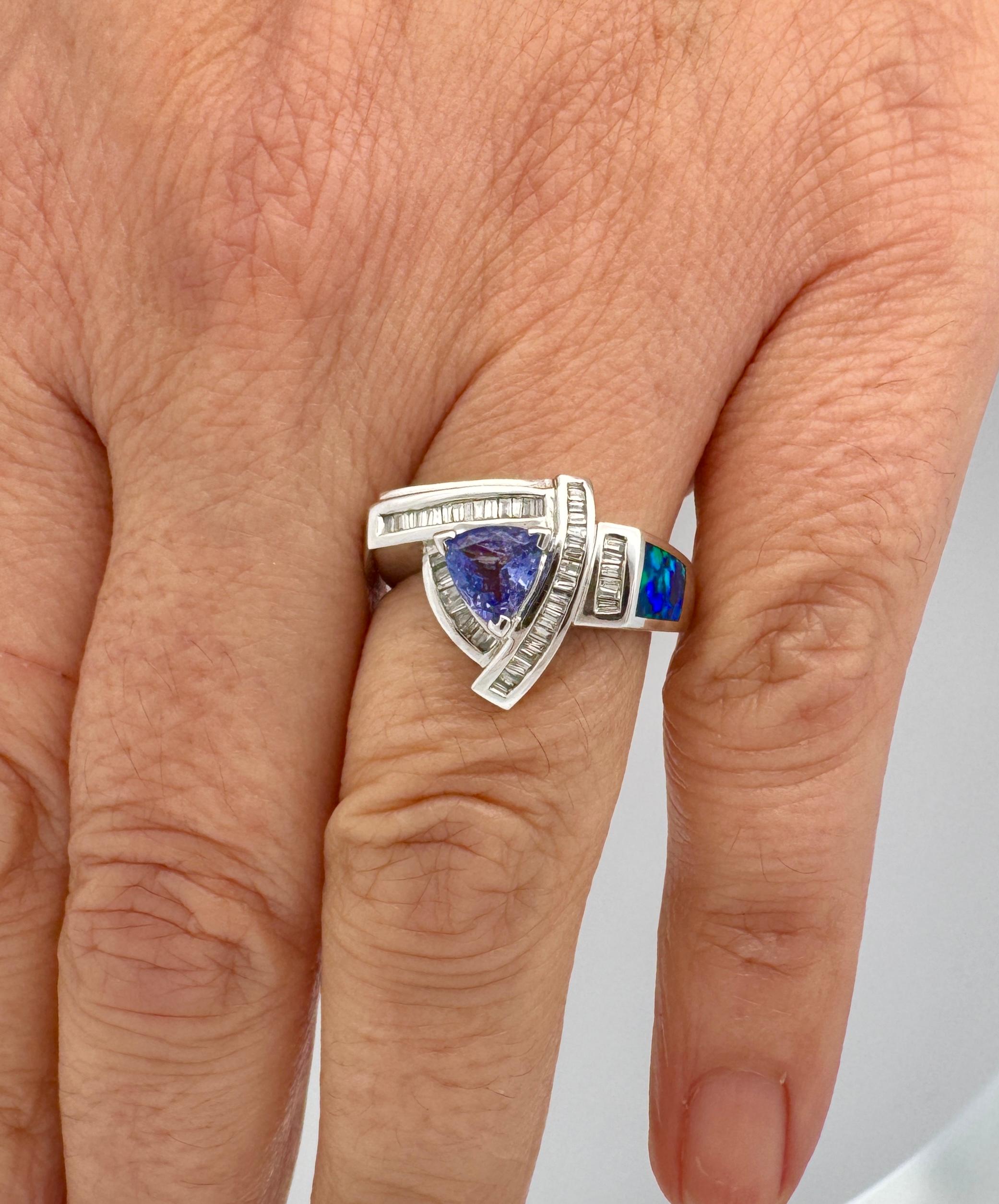 Vintage Natural Tanzanite, Inlaid Opal, and Diamond Cluster Ring in 14K Solid White Gold. Prong and tension set. 

Details: 
- Tanzanite: 0.55 Carats, Trillion cut 
- Diamond: 0.35 Carats, Baguette Cut 
- Opal: 1 Inlaid Opal, 6.5mm
- Ring Weight: