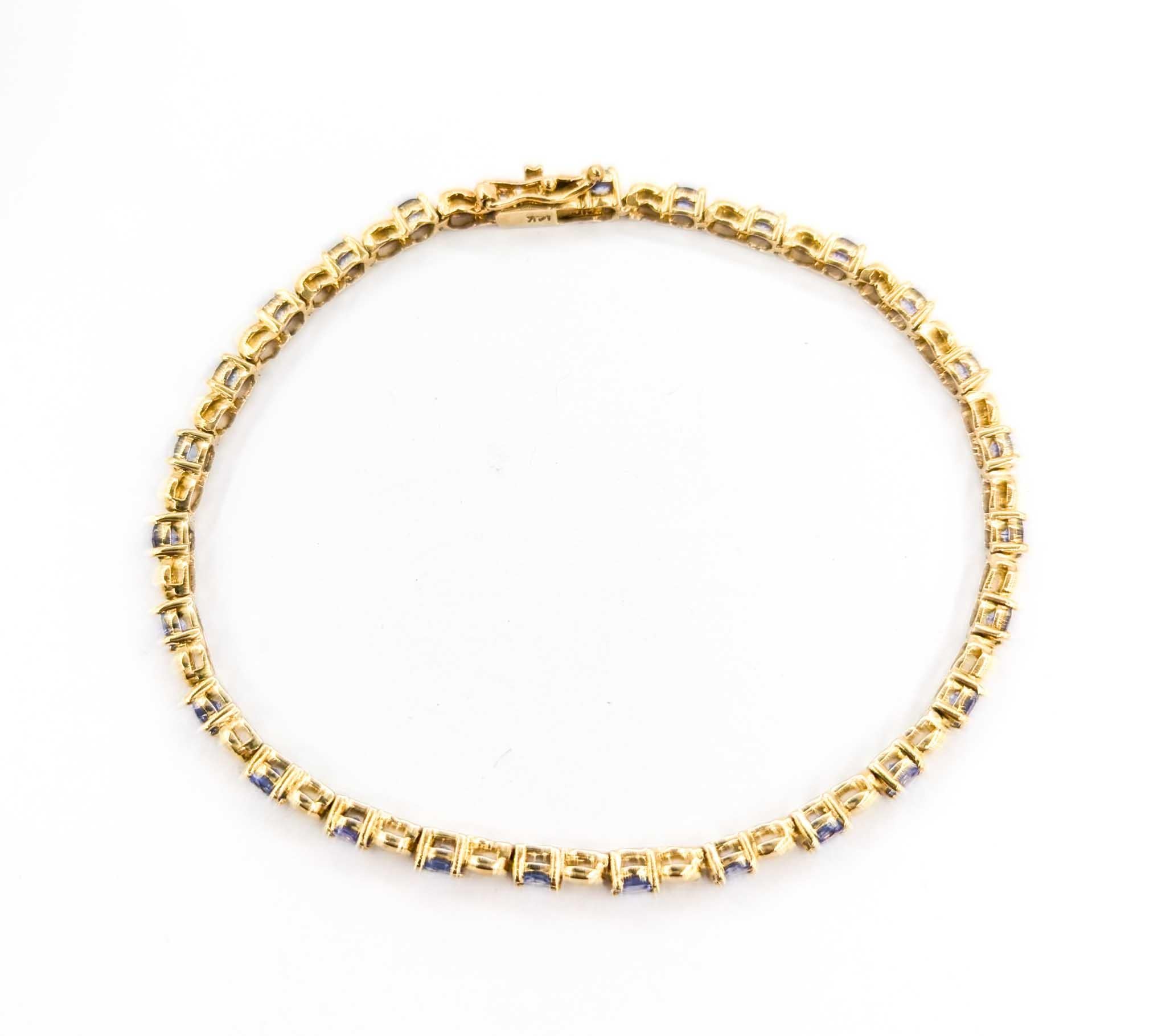 Vintage Tanzanite Line Bracelet in Yellow Gold

This beautiful bracelet is crafted in bright 14k yellow gold and features 3.24ctw of tanzanite, the birthstone for December. Tanzanite is believed to enhance communication and spiritual awareness,