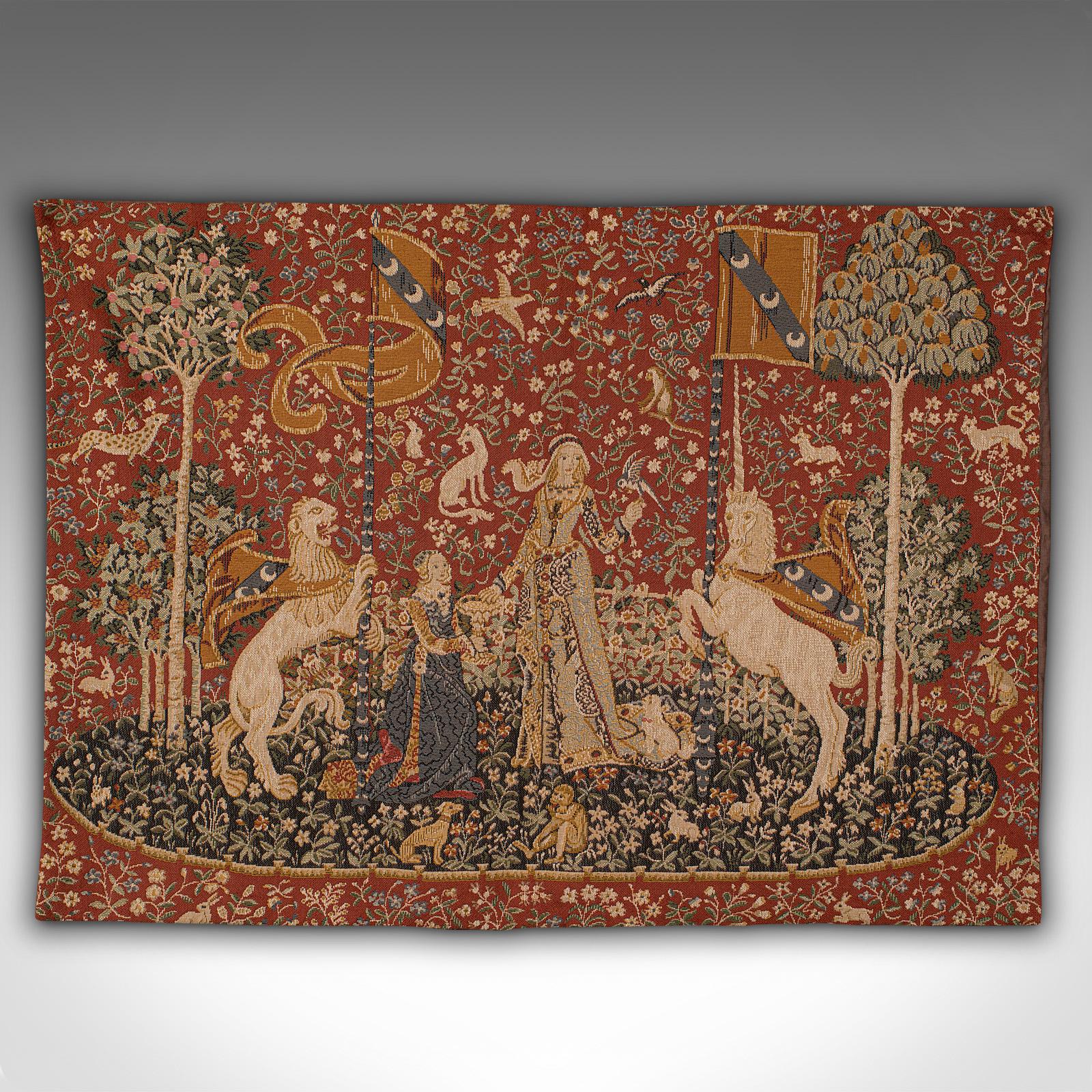 This is a vintage tapestry. A French, needlepoint scene depicting The Lady and the Unicorn, dating to the late 20th century, circa 1980.

This delightful tapestry is a quality recreation of the 15th century renaissance series of tapestries known