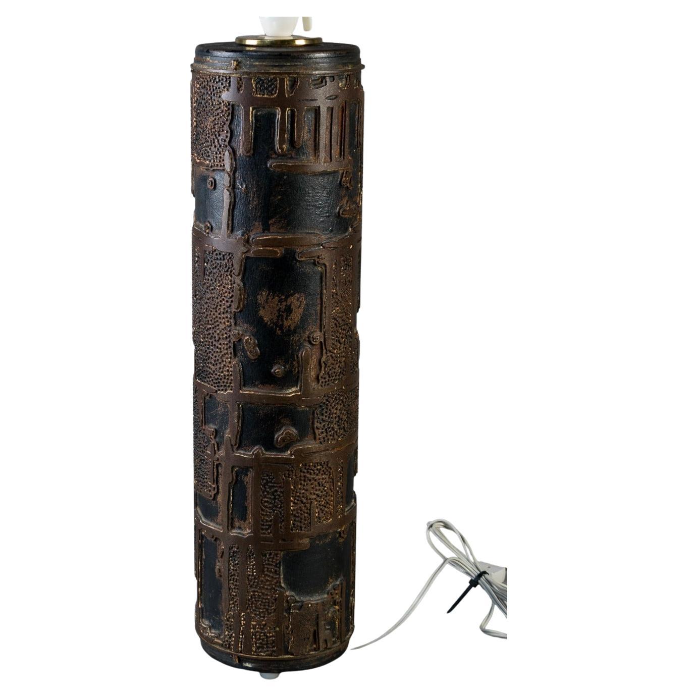 Danish industrial table lamp, modified from vintage tapestry wallpaper roller in metal.

A stunning large-scale vintage wallpaper rollers as lamps, circa 1940. Heavy metal cylinder form decorated with solid brass motifs. Accents of lacquered steel