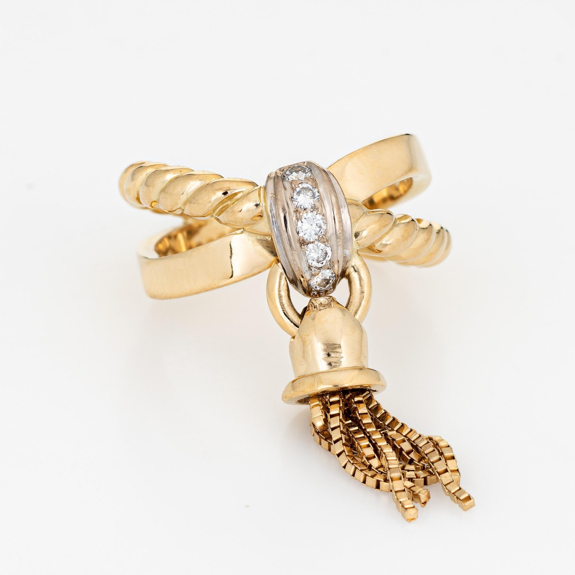 Stylish vintage tassel ring (circa 1980s to 1990s) crafted in 14 karat yellow gold. 

5 round brilliant cut diamonds total an estimated 0.05 carats (estimated at H-I color and SI1-2 clarity). 

The tassel is hinged to the diamond set mount, allowing