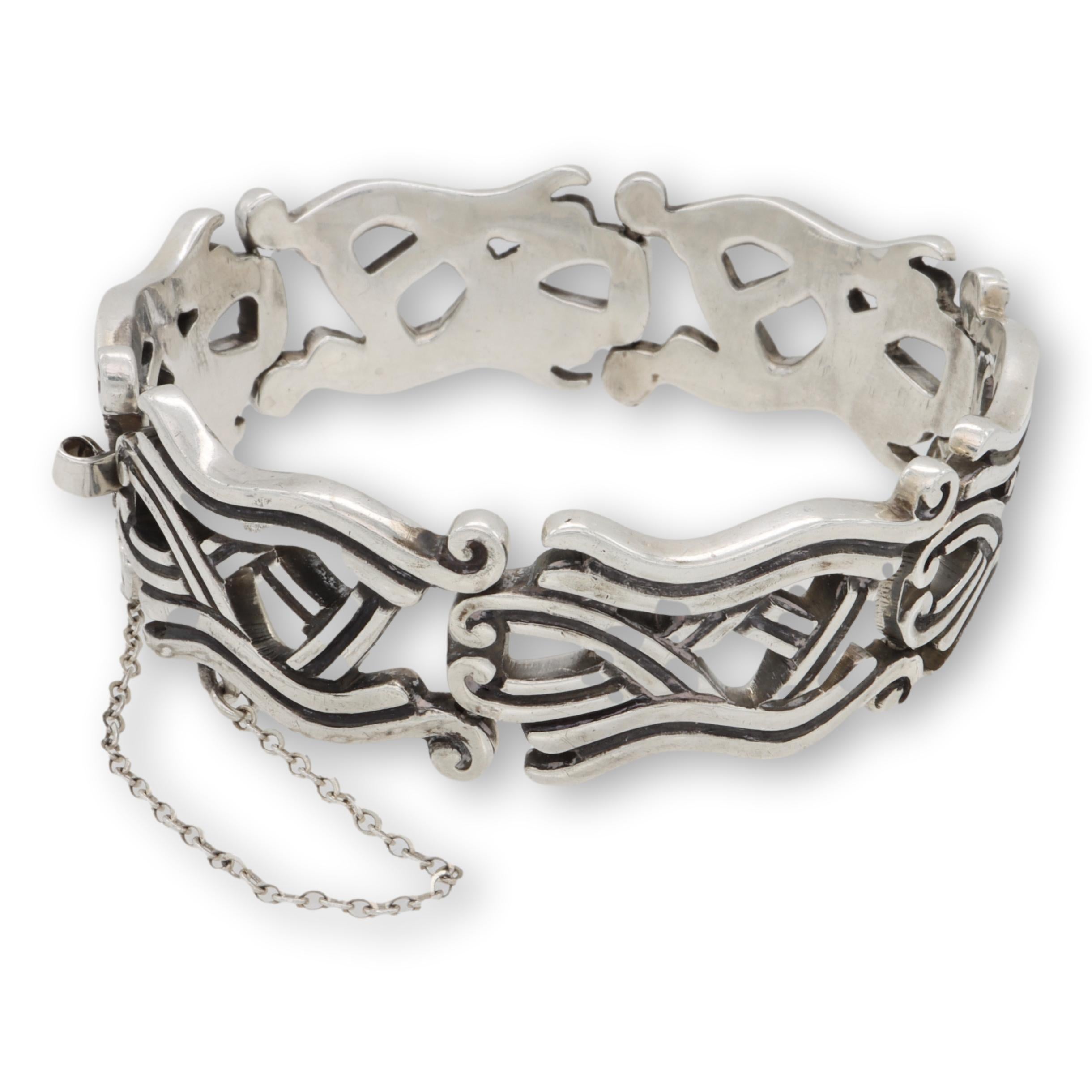 Vintage bracelet from TAXCO Mexico crafted in very fine sterling silver from the 1940's. This bracelet has Aztec open scroll work designs throughout with a blackened silver finish. This bracelet measures 8
