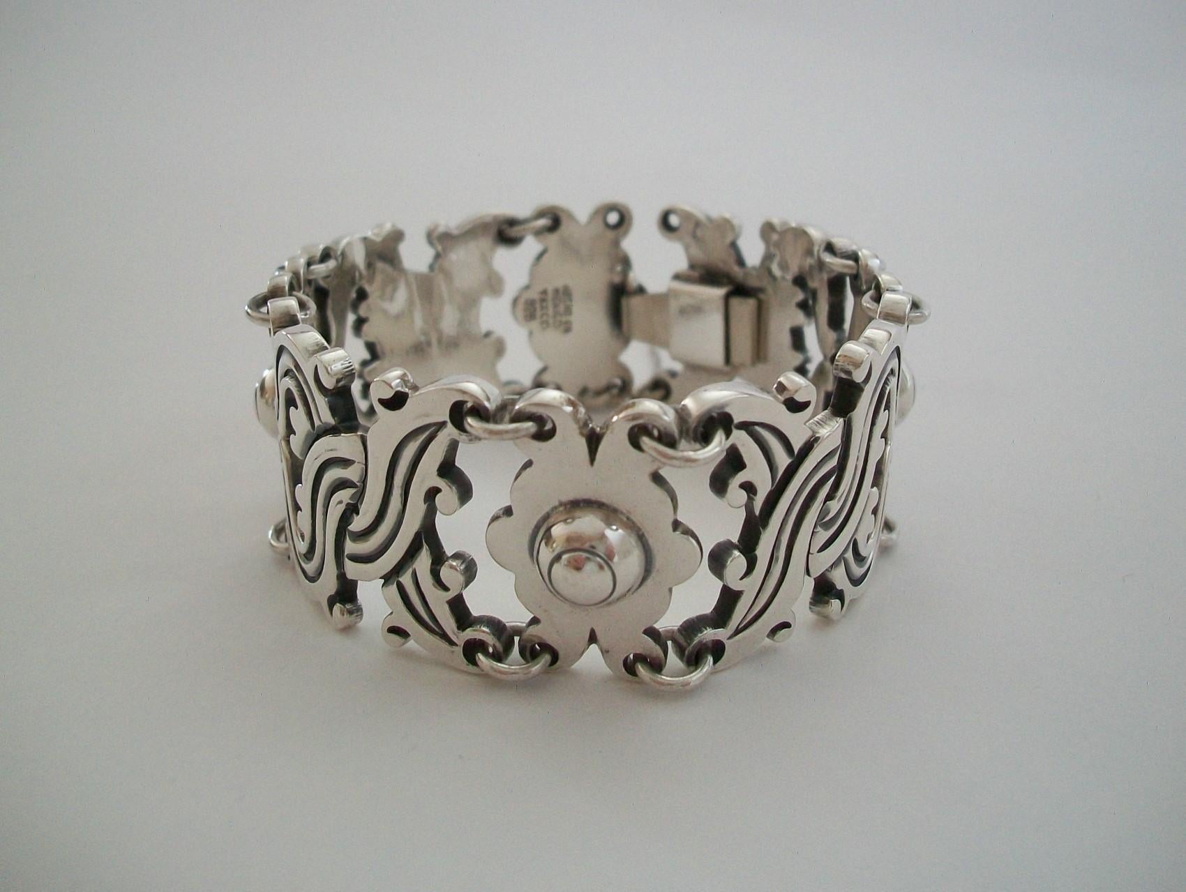 Vintage Taxco heavy sterling silver bracelet - fine quality - featuring linked scrolling panels with incised patterns - box clasp closure with safety chain - marked Hecho en Mexico / Taxco / 925 on last link - Mexico - circa 1980's.

Excellent