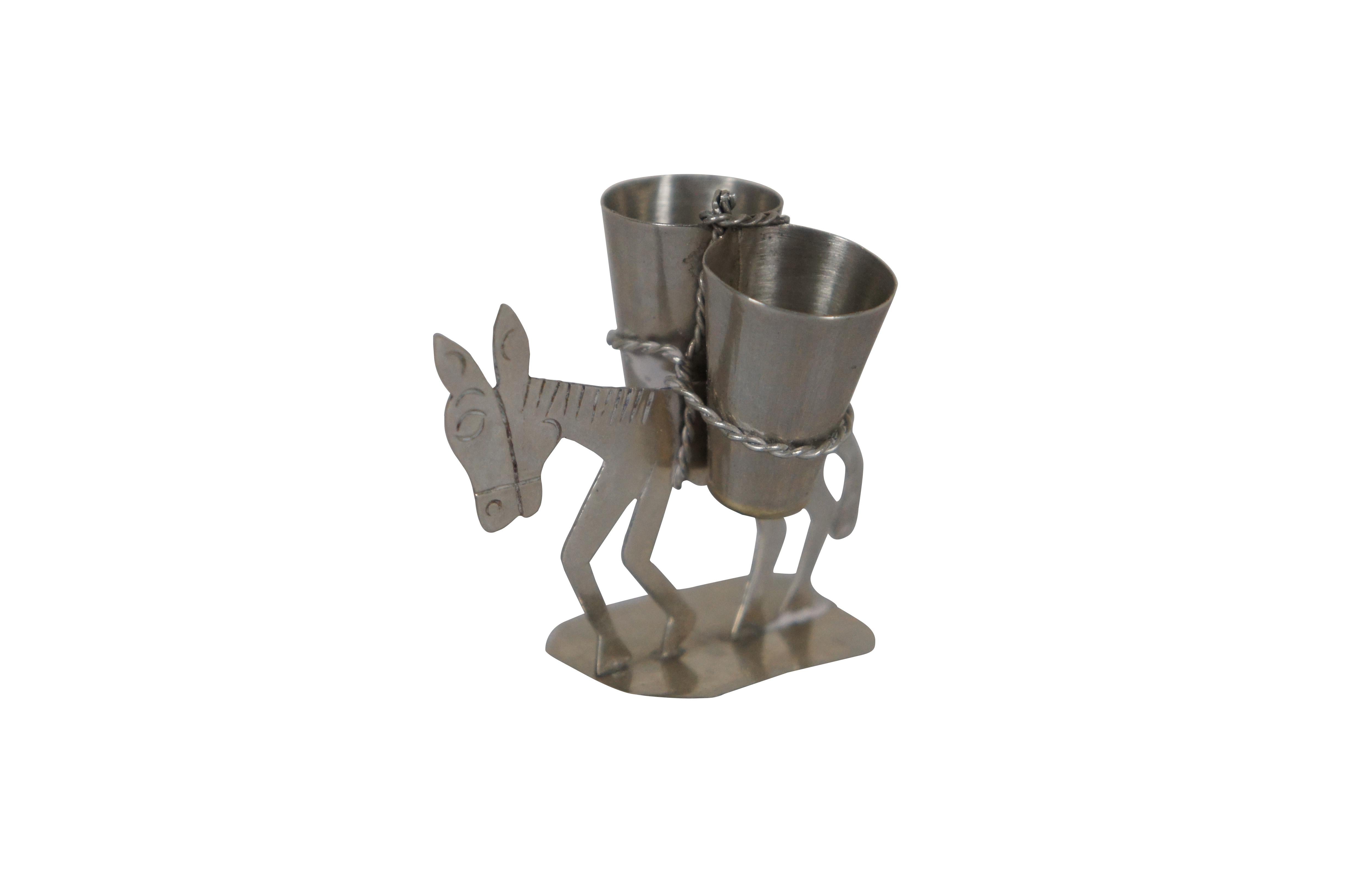Vintage Mexican silver toothpick holder in the shape of a two dimensional donkey / burro carrying a pair of containers lashed with rope. Marked Taxco on base.

Dimensions:
2