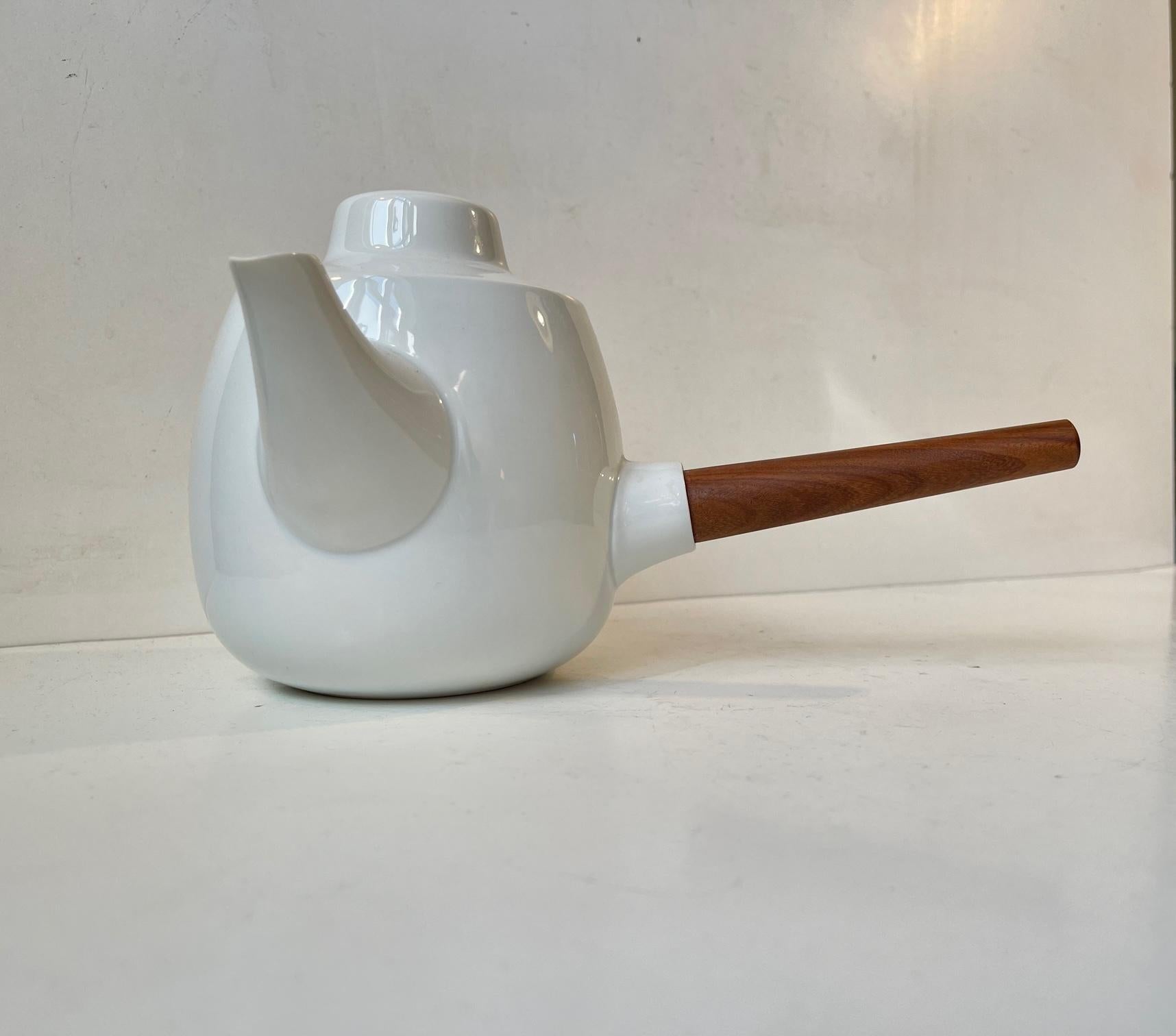 Important design by Henning Koppel exhibited at the British Museum and Museum of Modern Art in New York. This set consist of a milk/sugar jug/bowl and the Koppel Characteristic teapot with its tapered handle in solid teak. It is called Form 24 and