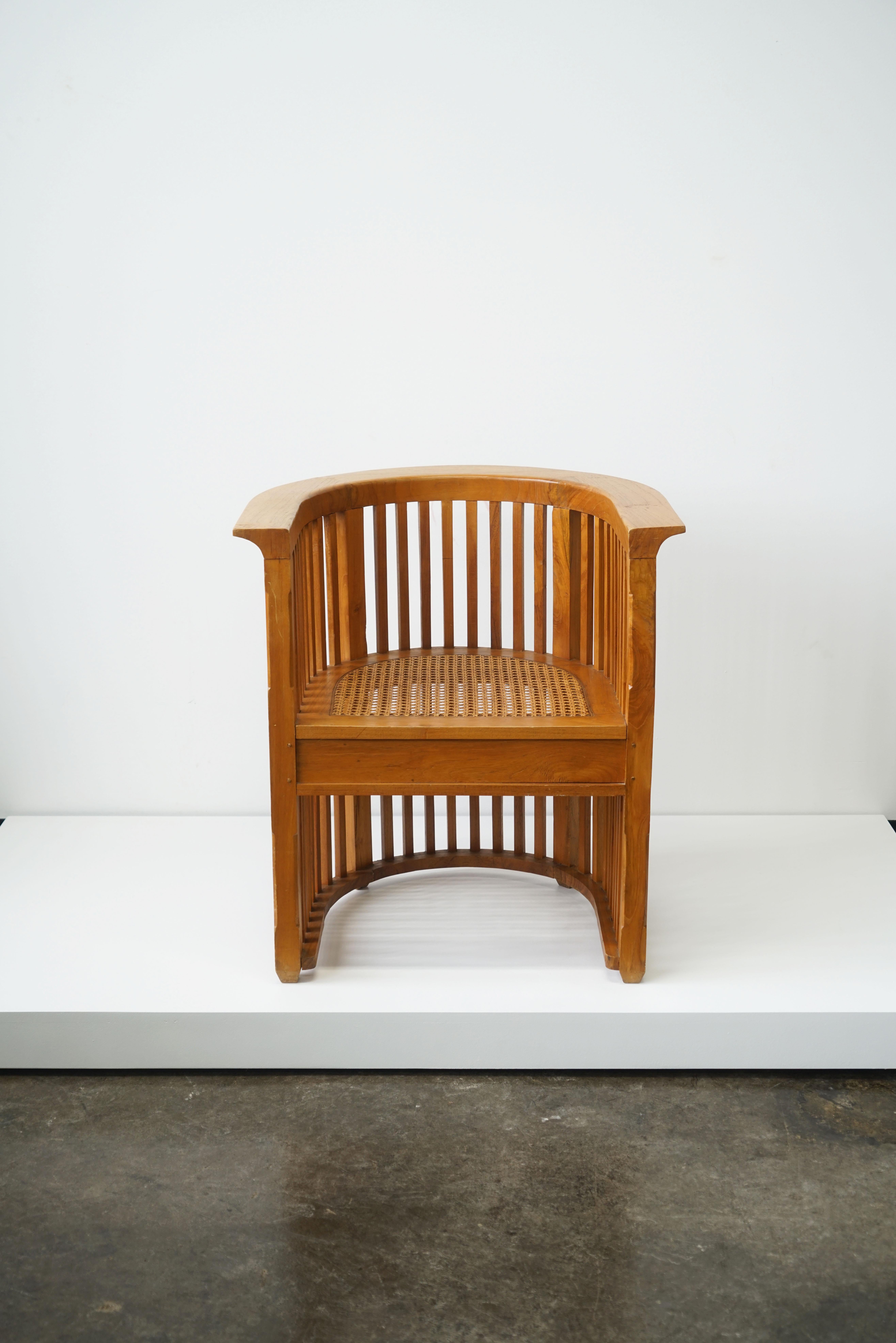 A solid teak wood barrel chair, in the manner of Josef Hoffmann.
With cane seat.

Measures: 28