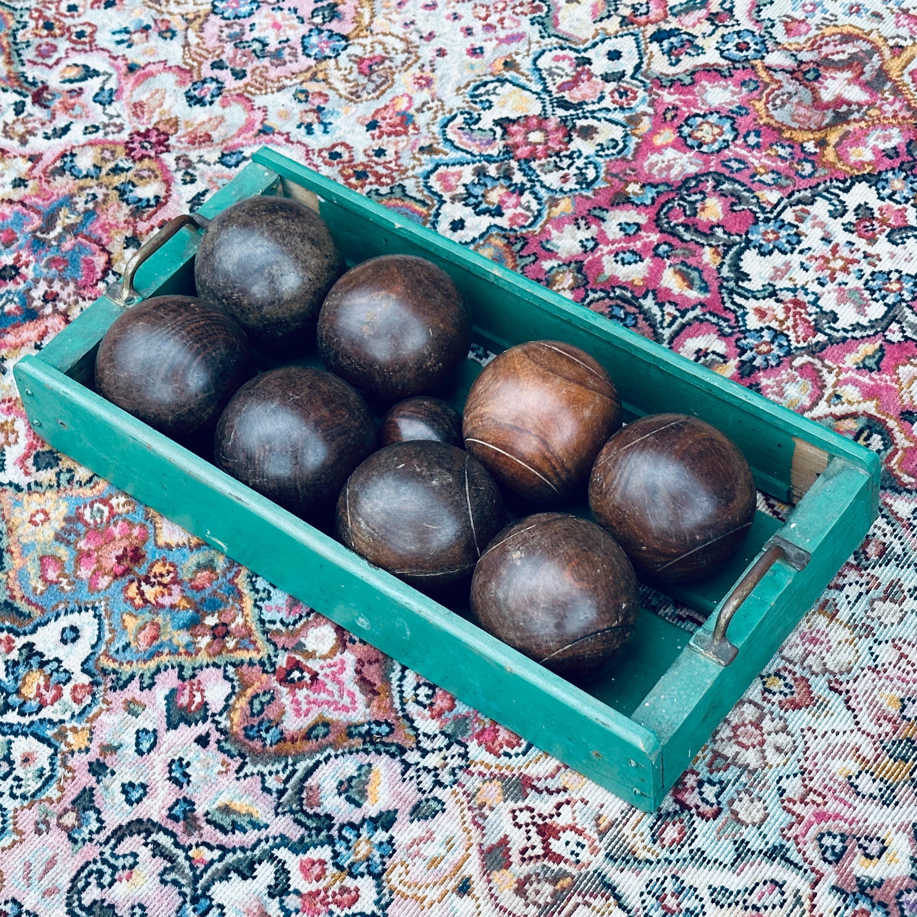 Vintage Teak Bocce Ball Set in Handmade Rustic Caddy. Included are four unmarked balls and four grooved balls along with the jack (little bocce) and rustic carrying caddy. The balls are fashioned from a very dense hardwood possibly Teak. ( Bocci ,