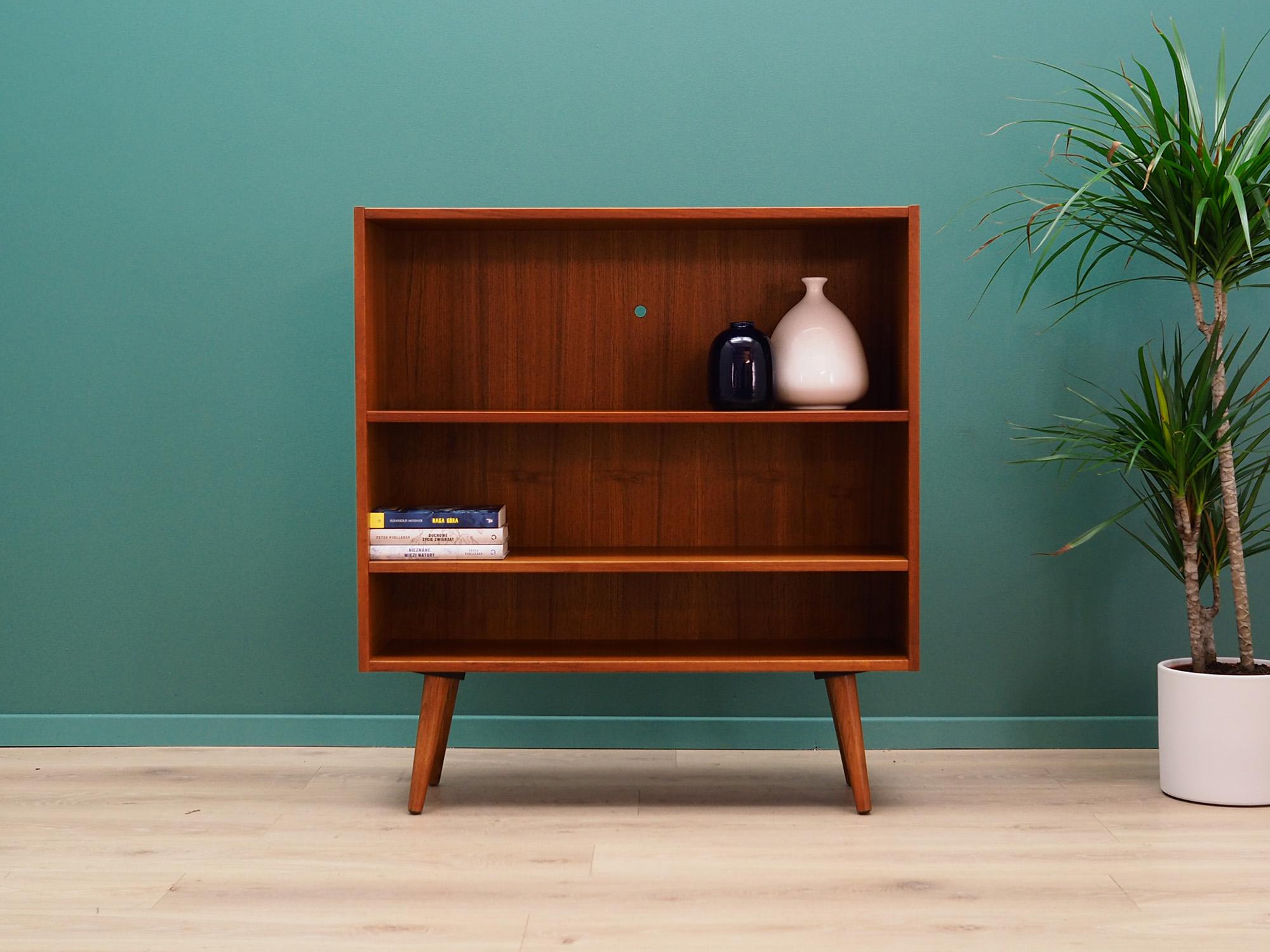 Phenomenal bookcase, library from the 1960s-1970s. Scandinavian design, Minimalist form. Furniture finished with teak veneer. The bookcase has two shelves. Preserved in good condition (small bruises and scratches, filled veneer cavities), directly