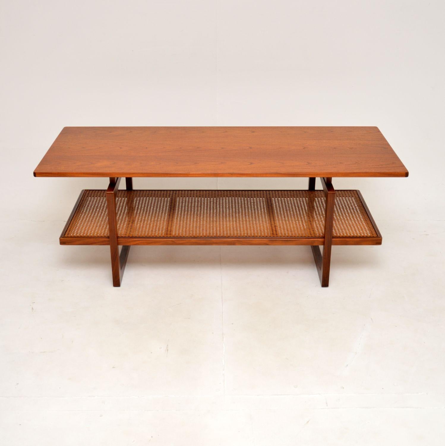 An extremely well made and very rare vintage teak coffee table by G Plan. This was made in England in the 1960’s as part of the Quadrille range.

This version is rarely seen, it is very large and has a stylish lower rattan covered tier. The quality