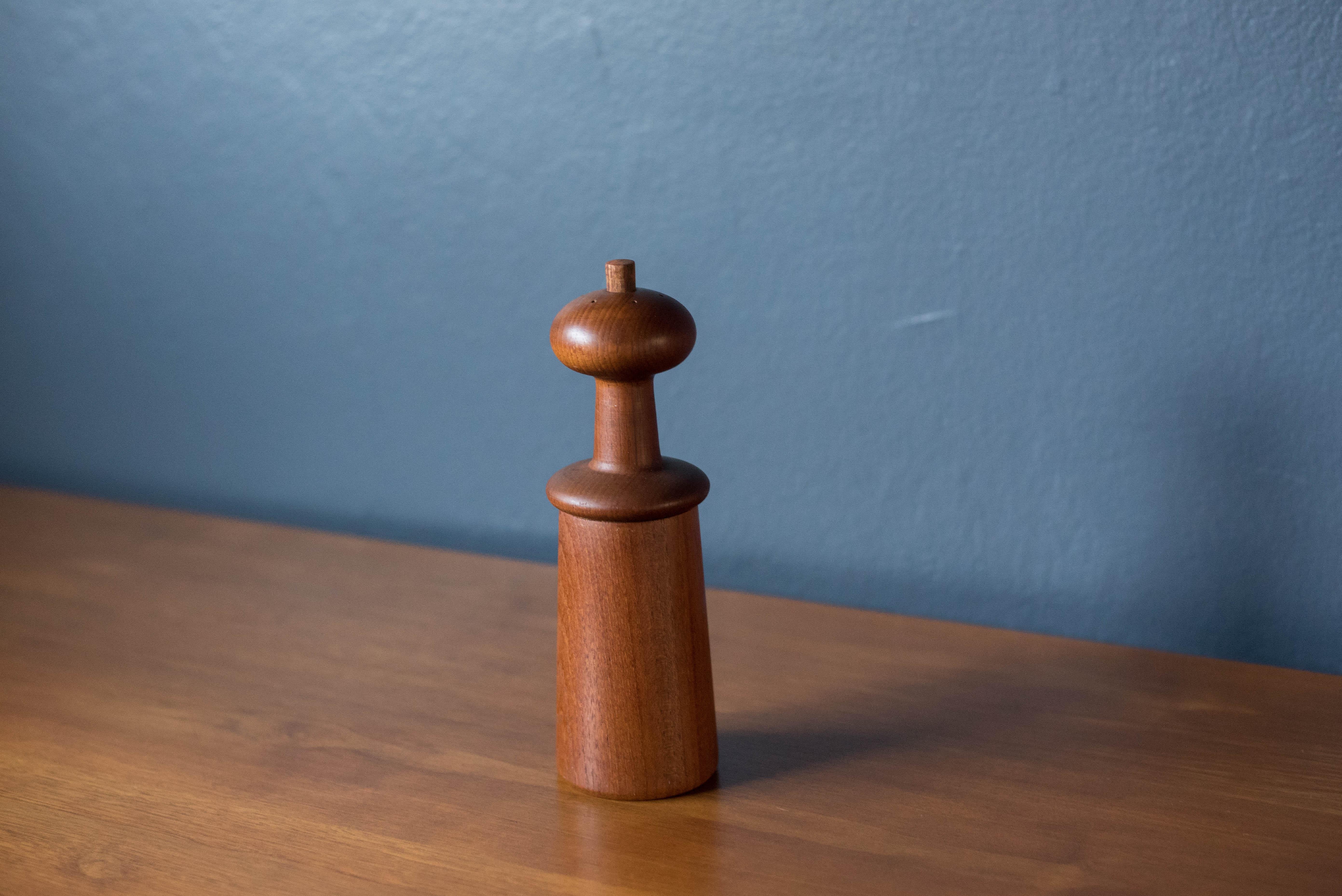 Mid-Century Modern sculptural salt and pepper mill in teak designed by Jens Harald Quistgaard for Dansk. This piece features a mushroom shaped top with a removable peg for filling salt. Includes a grinding mechanism on the bottom with makers label.