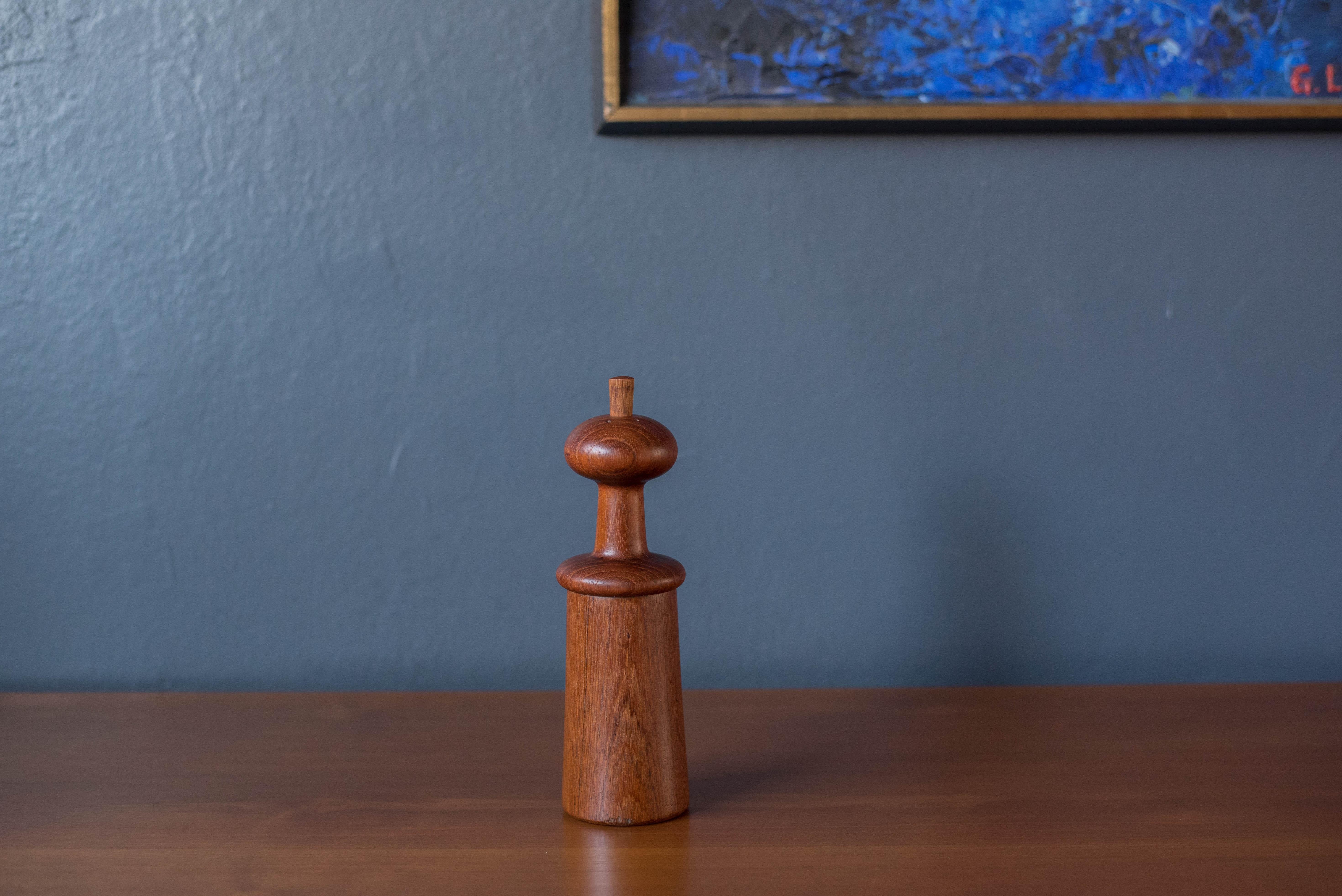 Mid-Century Modern sculptural salt and pepper mill in teak designed by Jens Harald Quistgaard for Dansk. This piece features a mushroom shaped top with a removable peg for filling salt. Includes a grinding mechanism on the bottom with makers label.
