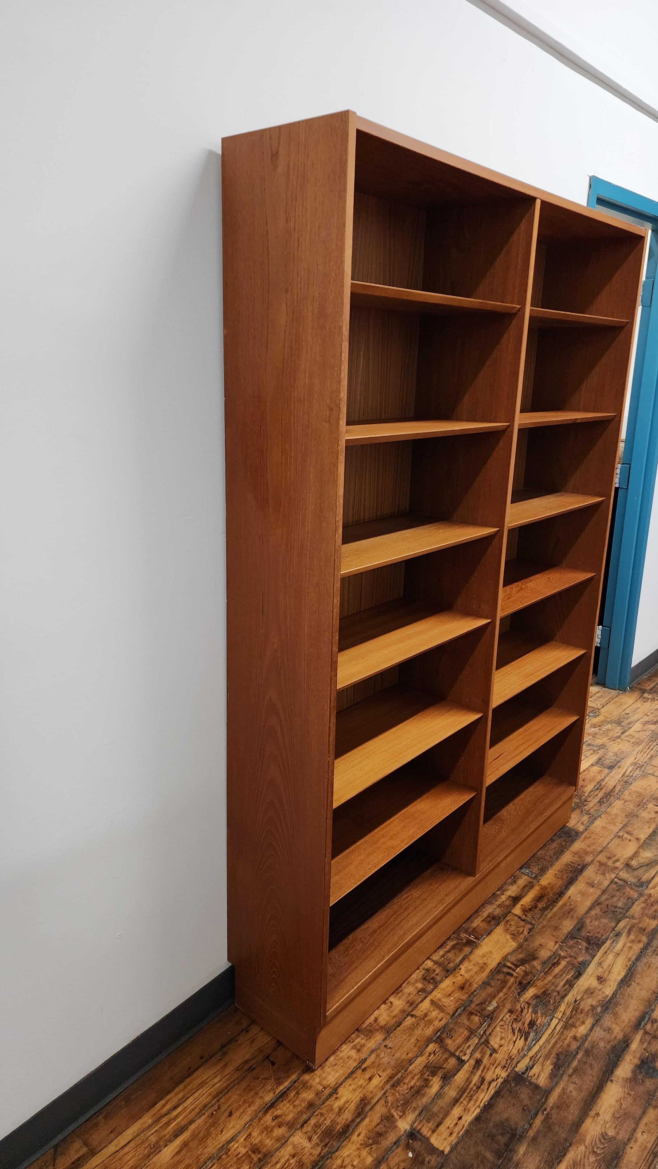 Beautiful vintage Teak Double bookcase designed by Carlo Jensen for Poul Hundevad.   The twelve knife edge shelves are adjustable.  this is in great vintage condition. 