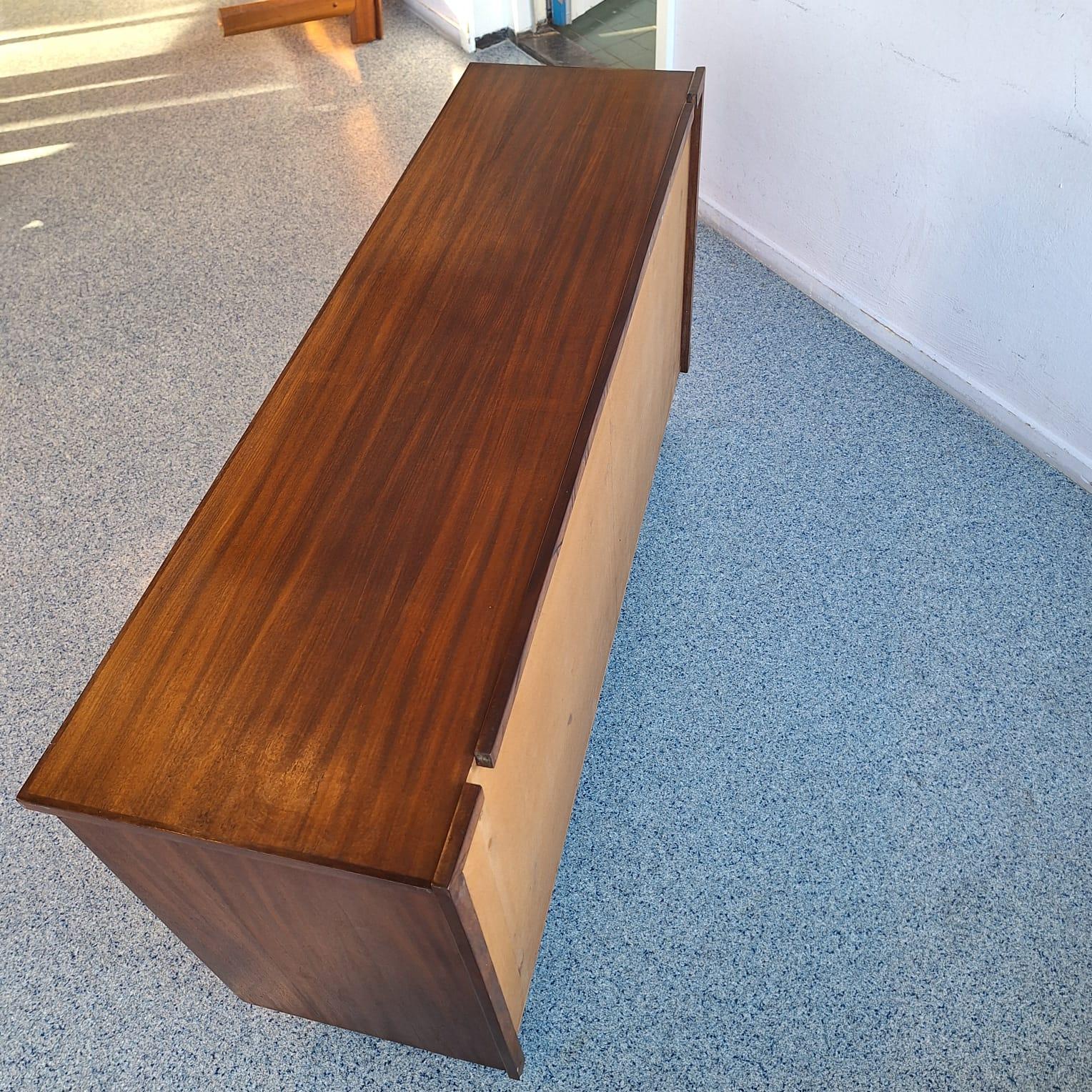 Minimalist teak sideboard on round metal legs. Timeless design There is storage space behind the two sliding doors, the inner shelves can be removed. Manufactured using teak veneer.

Beautiful oval shaped grips of solid teak

Made in Denmark, 1960s.