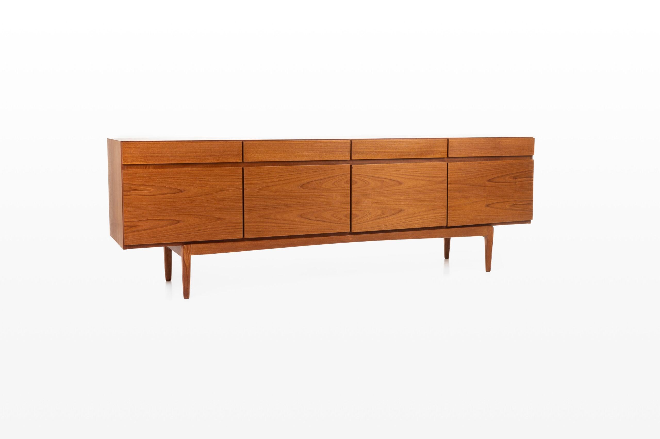 Teak ‘FA-66’ sideboard designed by Ib Kofod Larsen and produced by Faarup Møbelfabrik in Denmark in the 1960s. The sideboard has four doors, 4 drawers and plenty of storage space. The sticker of the producer is still present. This sideboard is a