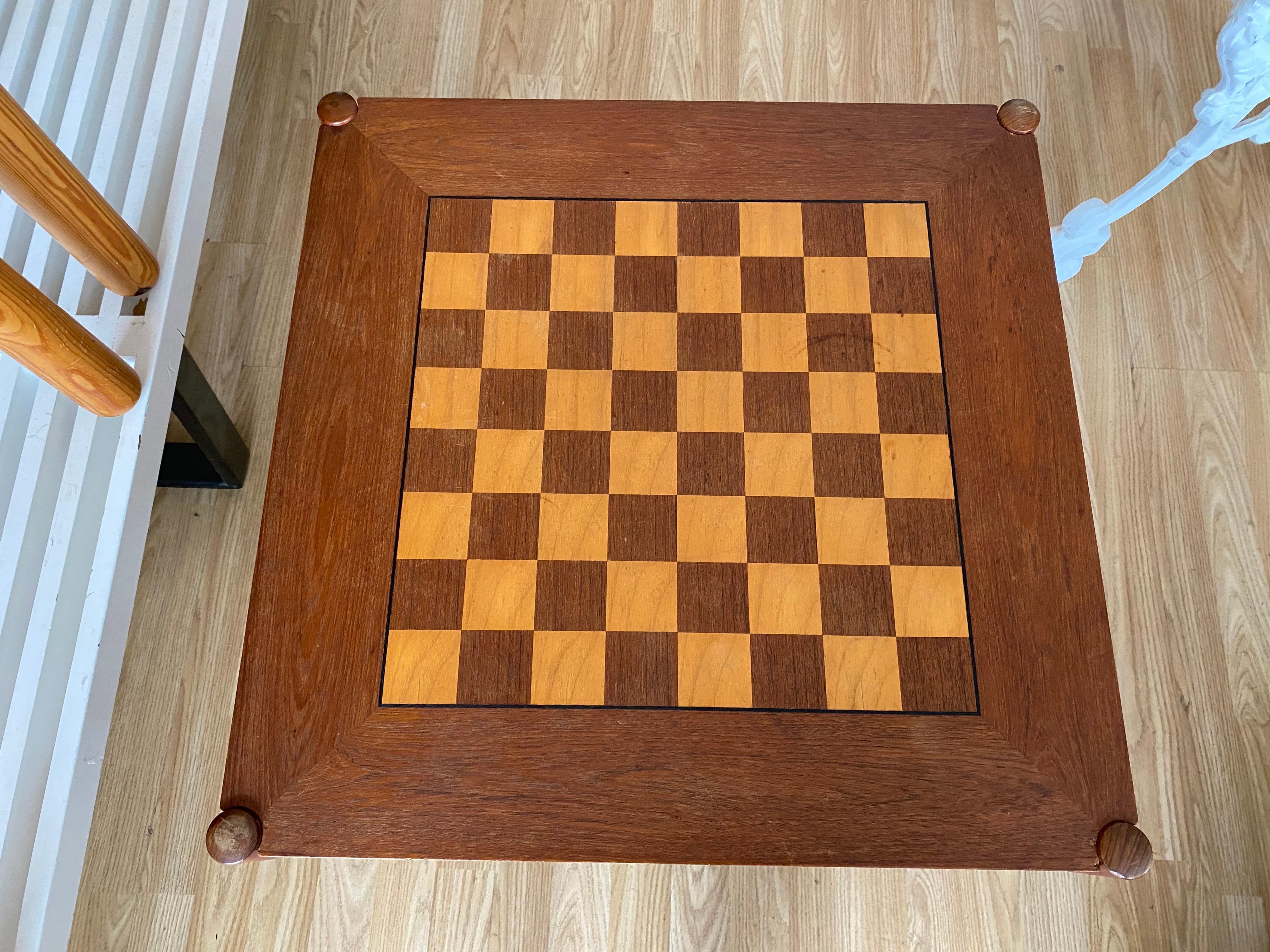 1960s vintage flip-top teak chess table made in Denmark designed by Georg Petersens. With a flip top, this table features a chessboard on one side and teak on the other. Vintage table is in good overall condition.