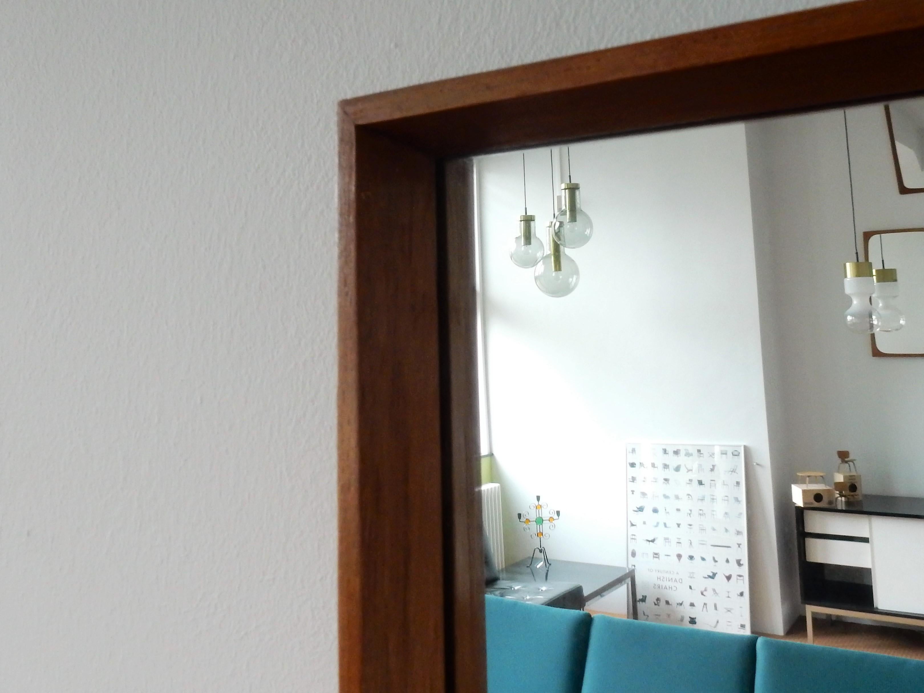 This is a very nice rectangle shape vintage mirror with a solid teak frame with a depth of 3 cm. It comes from its first owner and is most likely of Danish origin. The mirror has similarities with the mirrors of Luxus, AM Spelje and Pedersen &