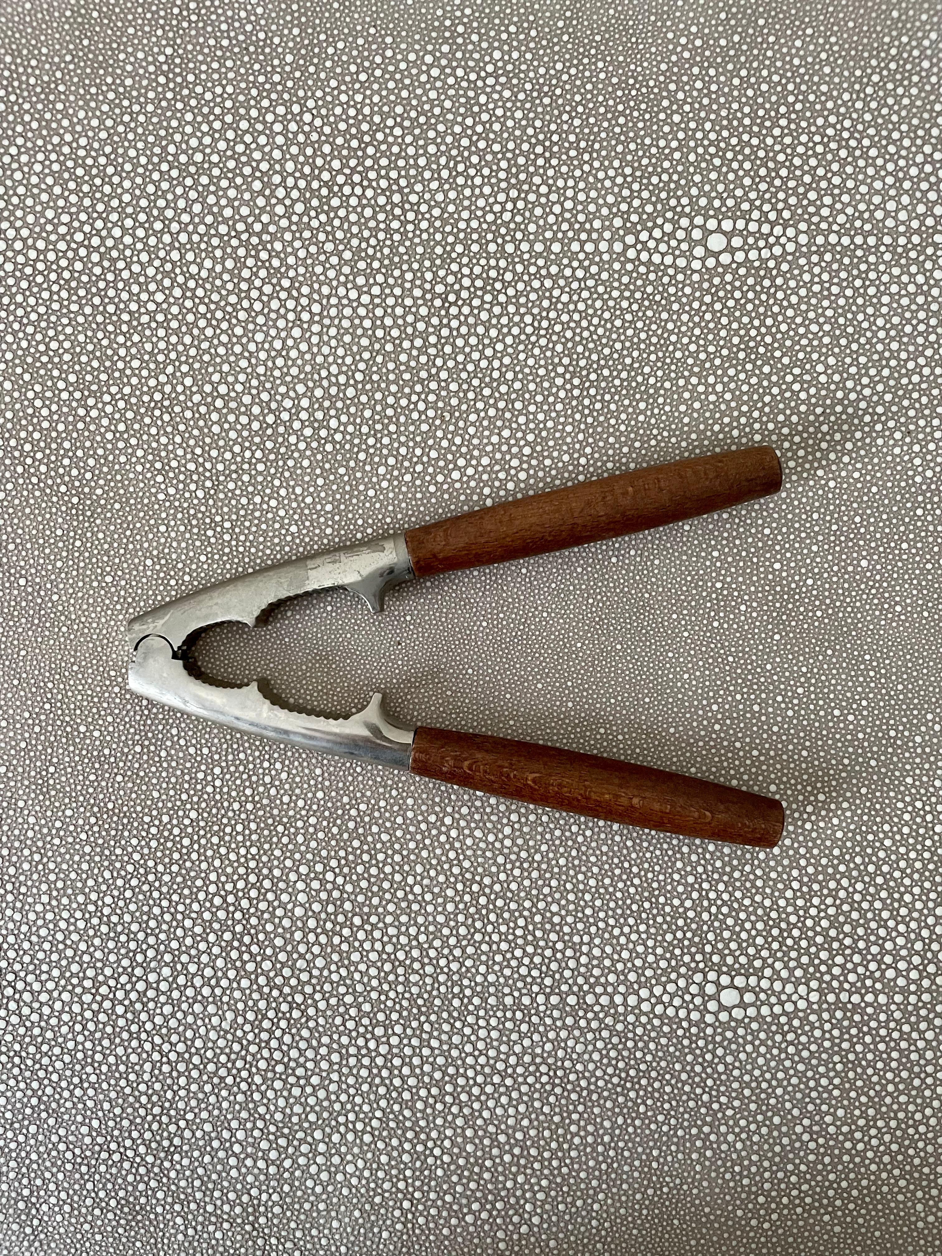 This sturdy nut cracker with solid teak wood handles has stood the test of time and bears memories of summer walnuts cracked in grandparents' homes. A practical piece that is also a decorative memory of a time when things were slower and simpler.