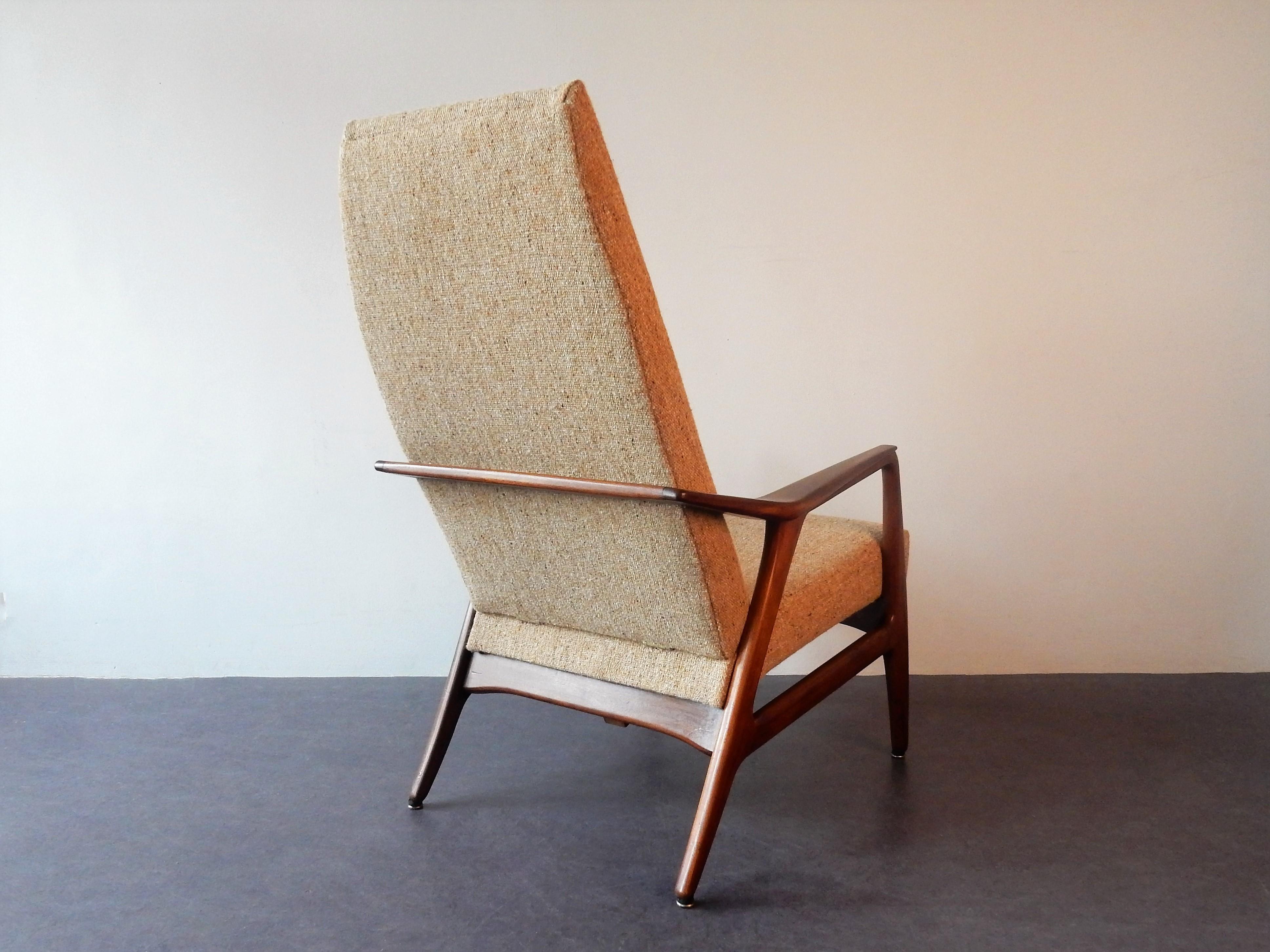 This high back lounge chair or armchair has been reupholstered in a 'Danish art Weaving' fabric/wool and new foam by a professional restorer. It is in a very good condition with minor signs of age and use in the teak frame. The combination of the