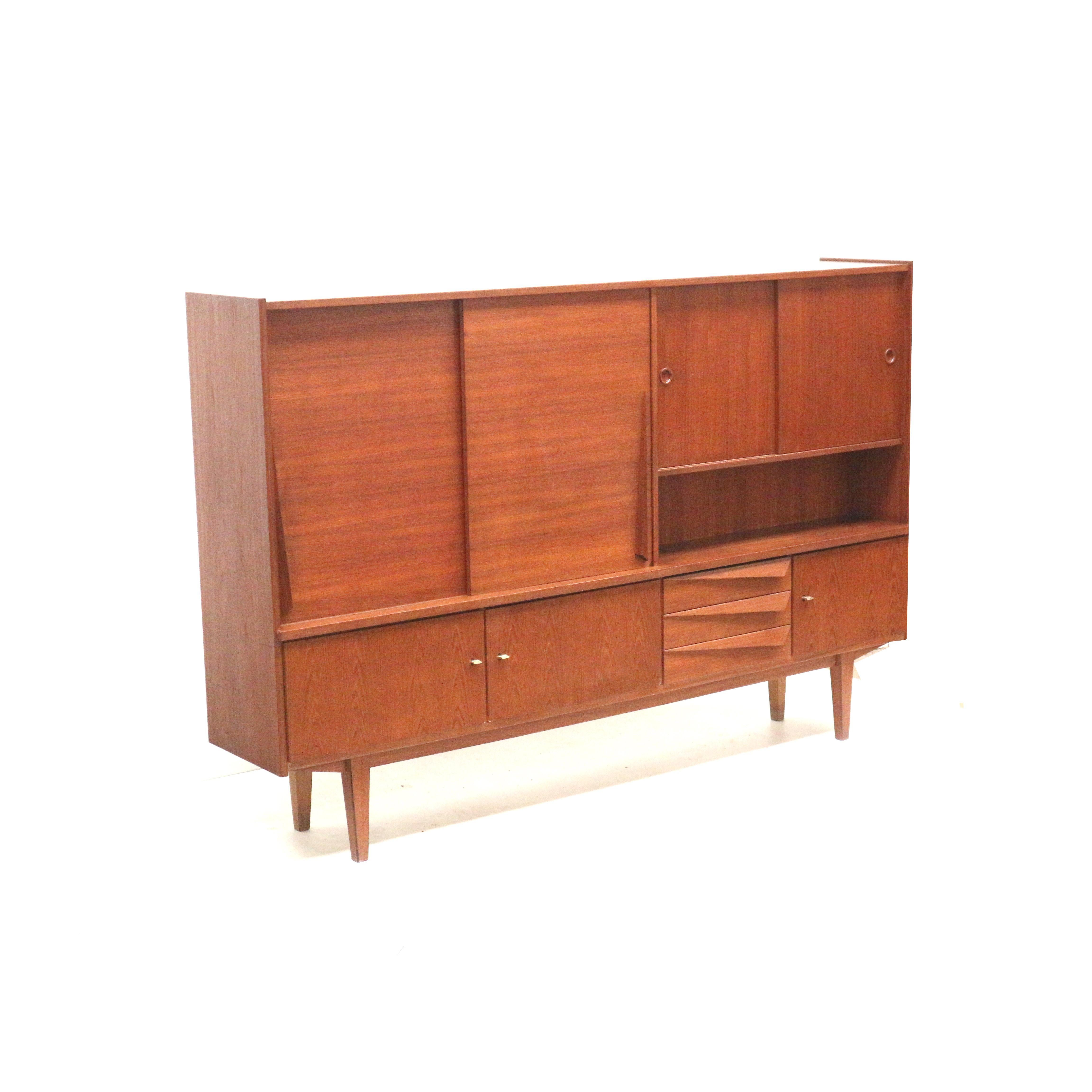 Vintage teak highboard/wall unit/sideboard from the 1960s.

Dimensions:
Width: 218 cm
Depth: 42 cm
Height: 144.5 cm

The sideboard has minor signs of wear consistent with its age.