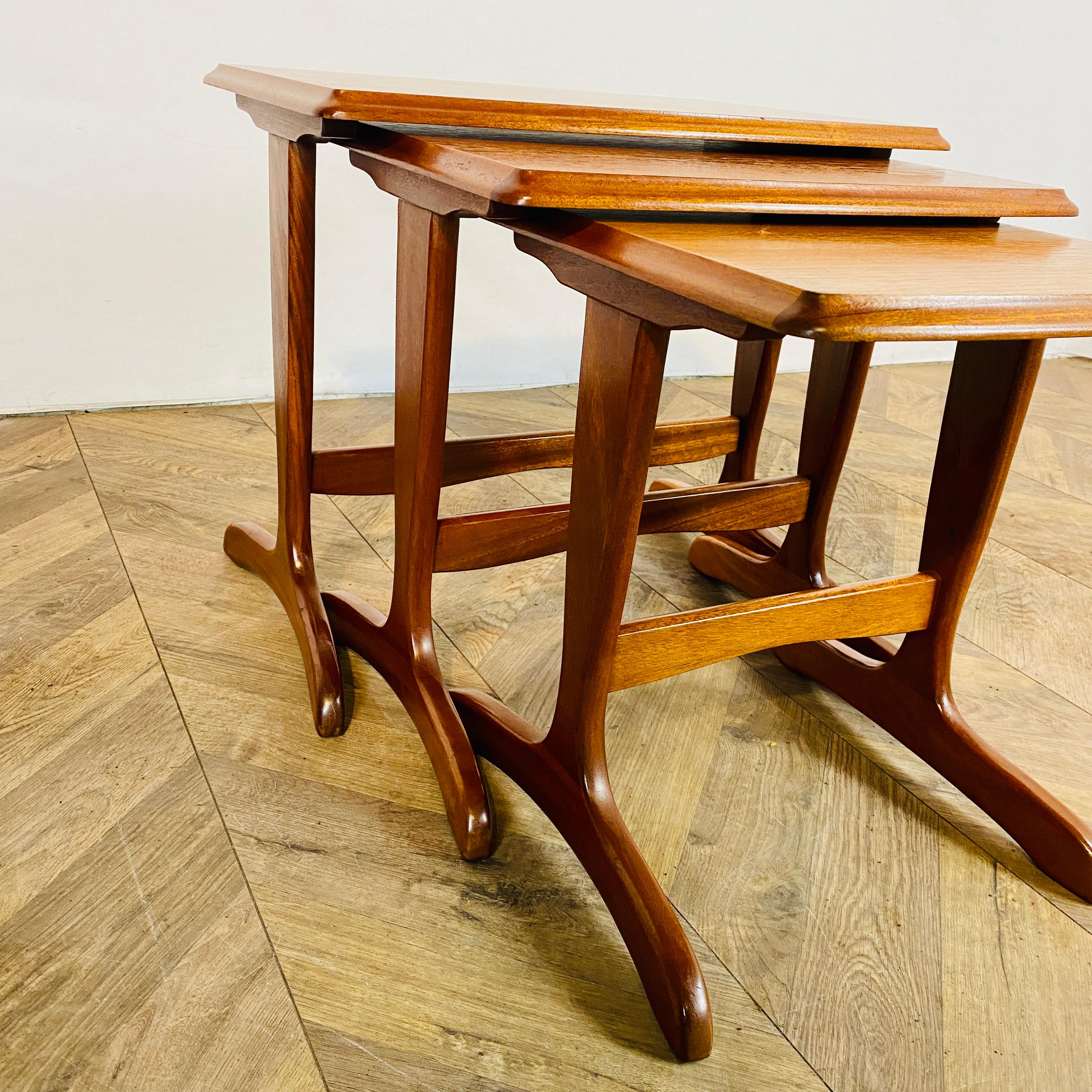 A lovely set of 3 midcentury teak nest of tables, circa 1970s.

The teak frames are in great vintage condition, with only minor wear and scuffs, in-keeping with its age and usage. (as pictured).
