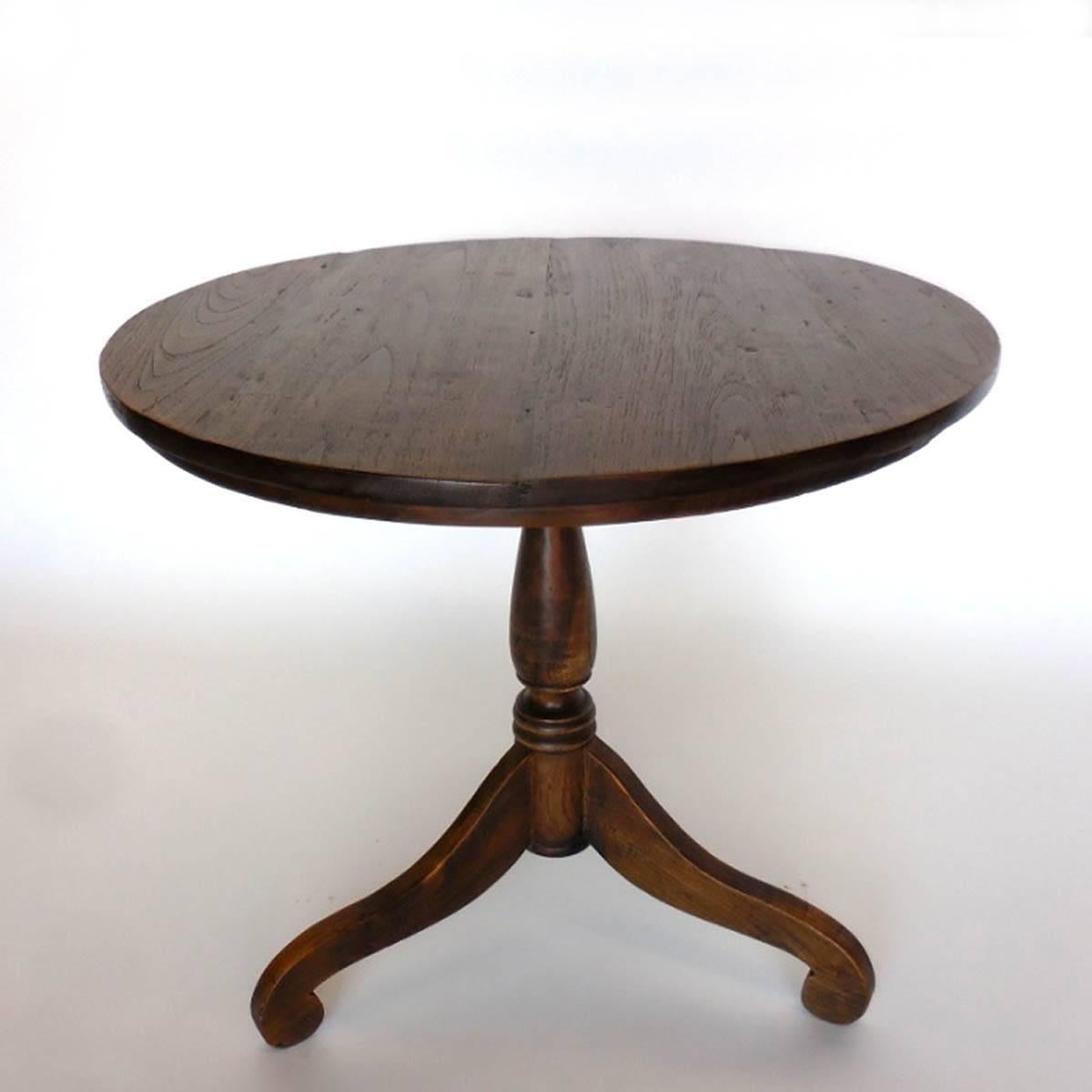Petite round teak table on tri-pod pedestal base. Beautiful wood and patina.
