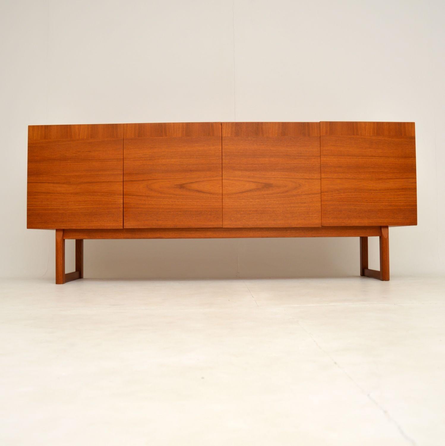 A stunning vintage teak sideboard designed by the famous Danish designer IB Kofod-Larsen. It was made in Sweden by Seffle, and dates from the 1960’s.

This has a wonderful sleek and minimal design, with four doors and two cabinets. The cabinets