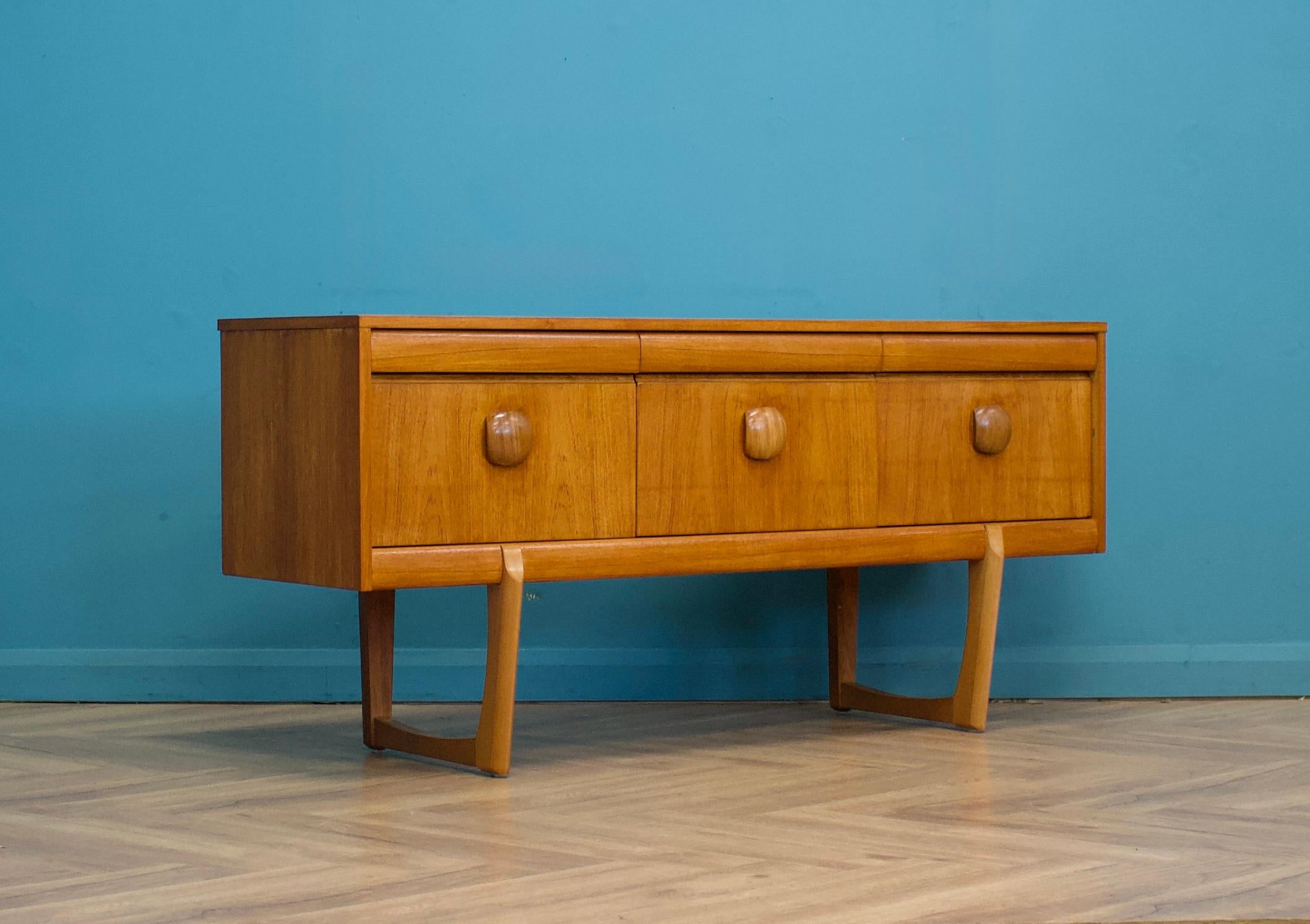 A teak compact sideboard from Elliots of Newbury - Circa 1960s.

Originally a dressing chest, this also could be used as a long low chest of drawers or a TV stand.

It features three small drawers and three larger.