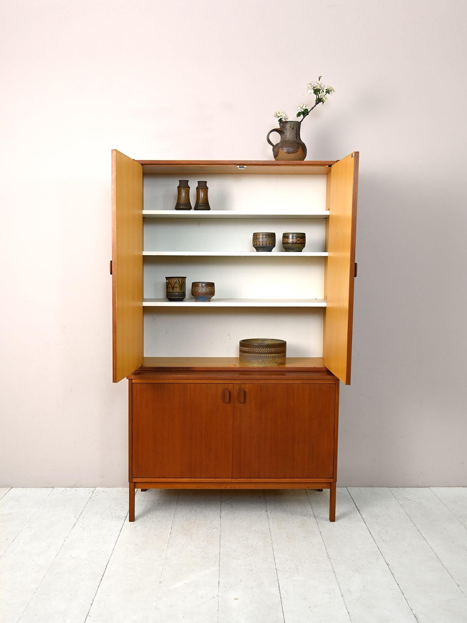 1960s cabinet of Scandinavian manufacture.

This sideboard of modest size turns out to be very capacious and functional. It consists of two parts, the bottom cabinet is a sideboard with a storage compartment equipped with shelves while the top part