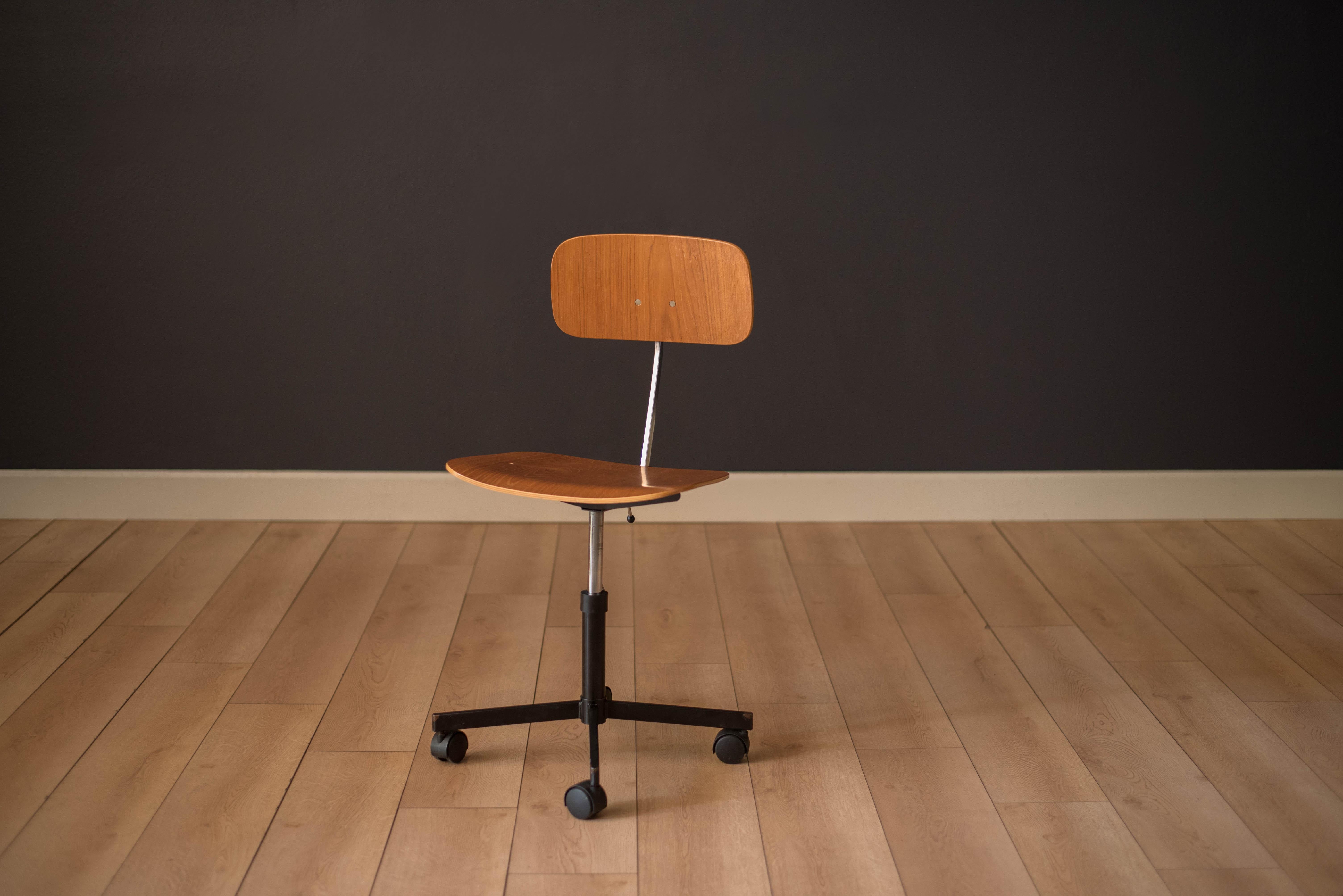 Danish teak desk chair designed by Jorgen Rasmussen for Kevi A/S. This piece includes an adjustable seat and backrest with a black swivel base. 

Seat height: 17.5 - 20.75